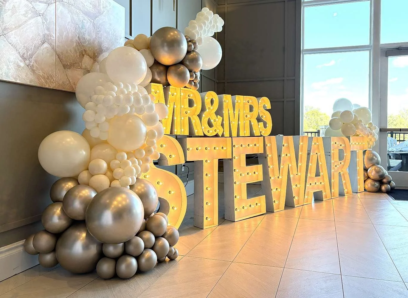 Organic balloon garland with marquee letters for wedding