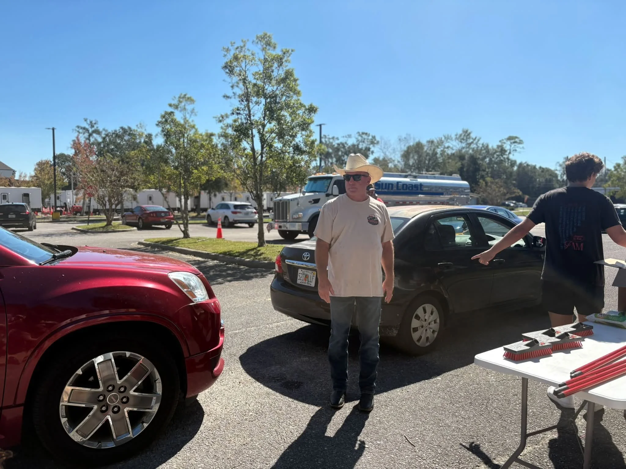 Ministry Village director Drayton Smith helping at an on-site outreach providing food, water, hygiene items, and cleaning supplies to people in the Pensacola community.
