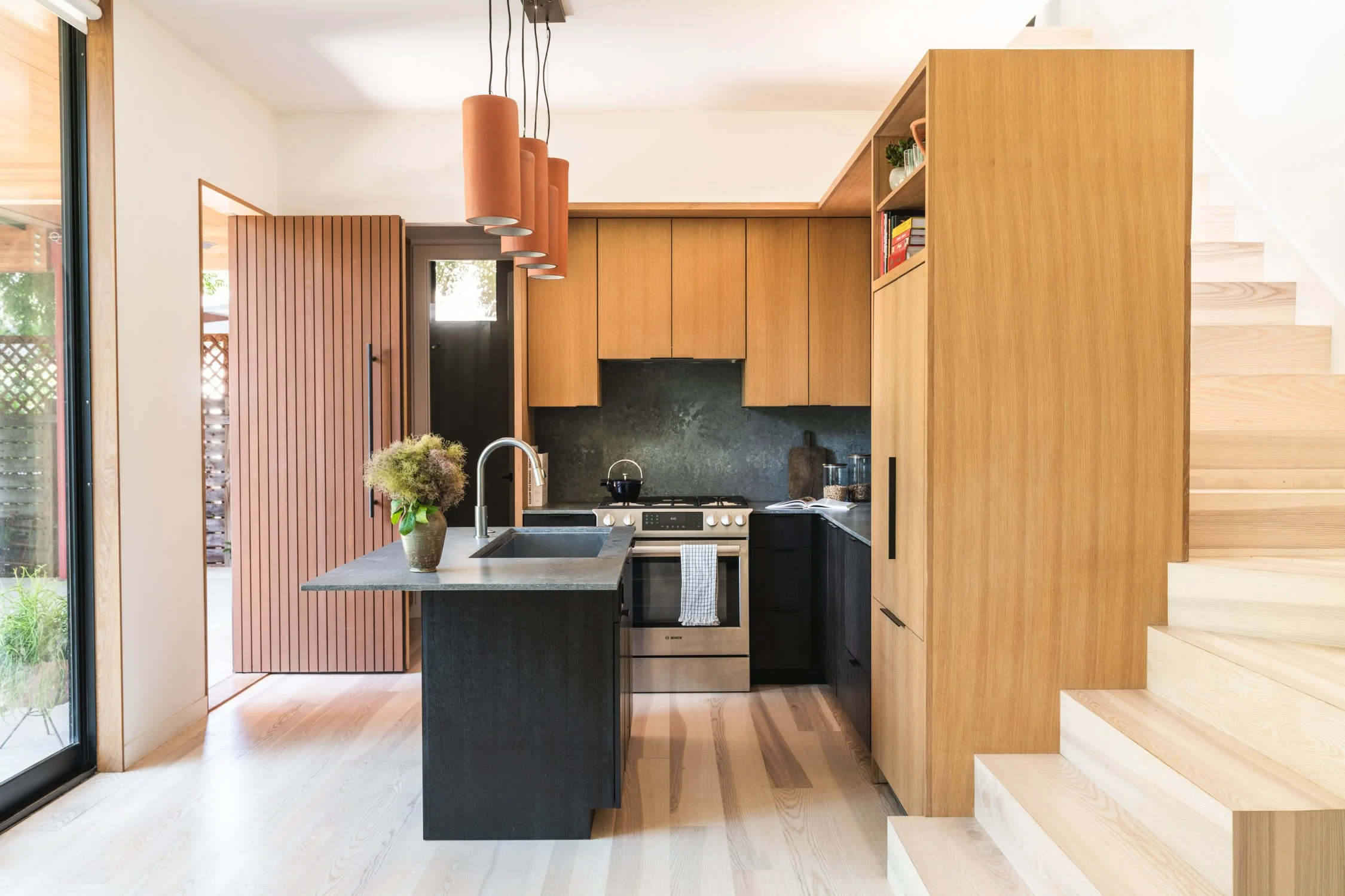 Compact chef's kitchen integrated into living space, Garden home Austin