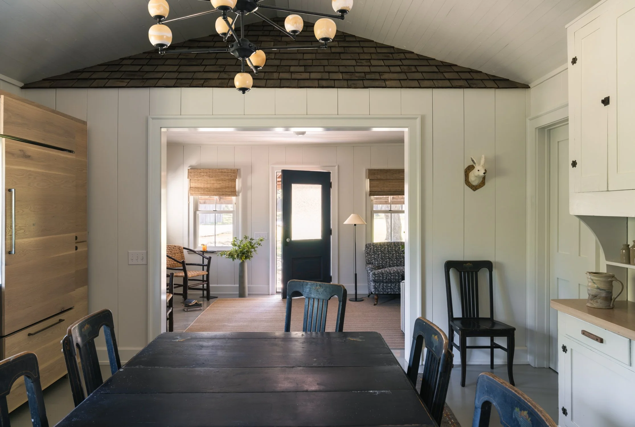 Kitchen to living shot with historic cypress shingles preserved in renovation, Ranchita project