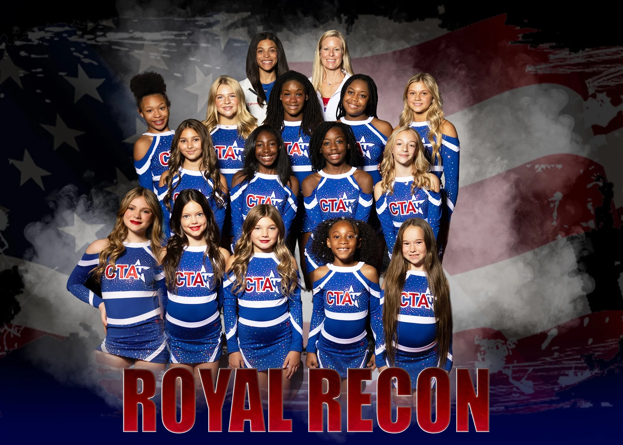 A group of young female cheerleaders and their two coaches posing for a team photo in front of an American flag background. The team is wearing blue, red, and black costumes with star designs, and the text "Royal Recon" and the Champions Training Academy logo are displayed at the bottom of the image.