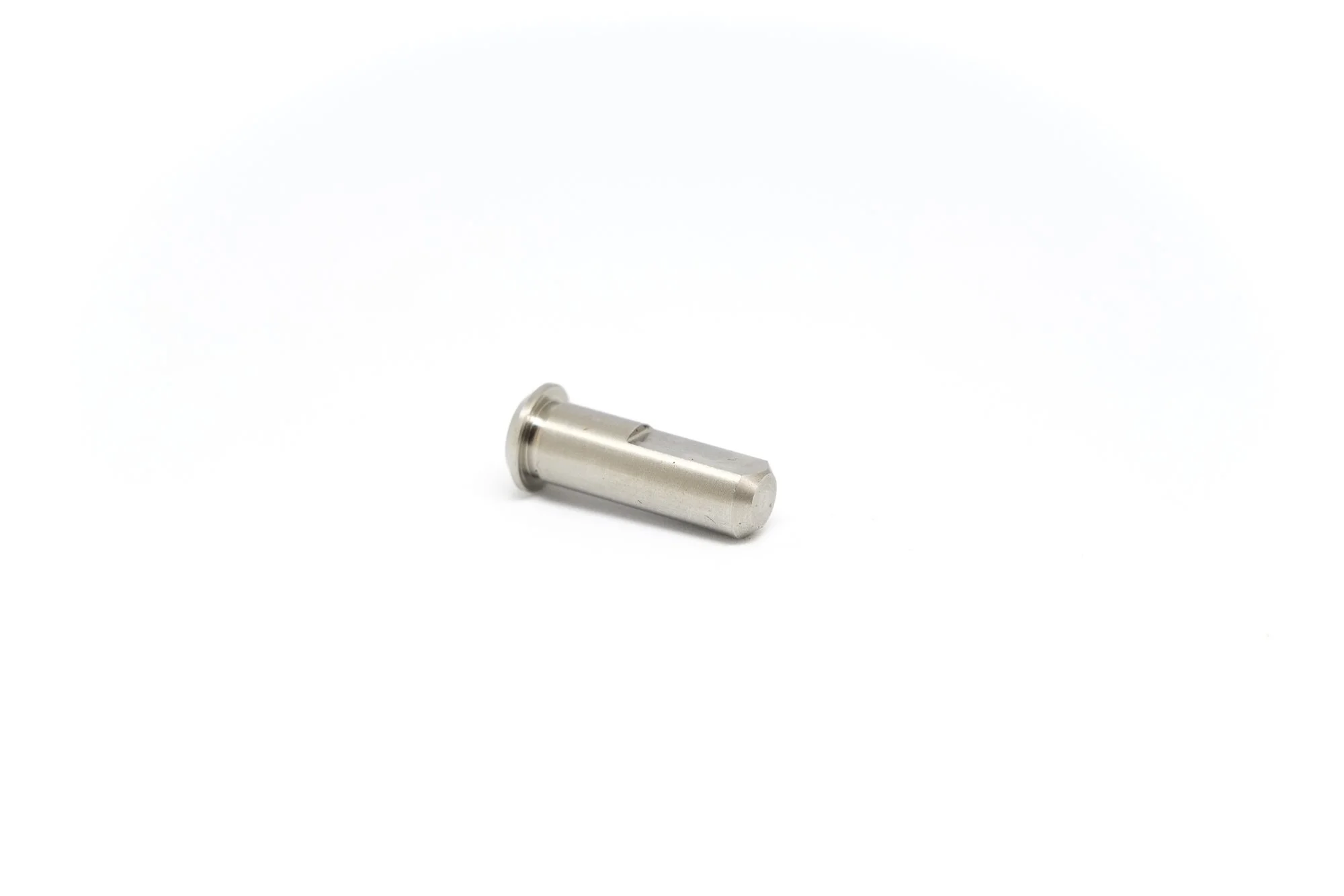 Small metallic cylindrical object on white background.