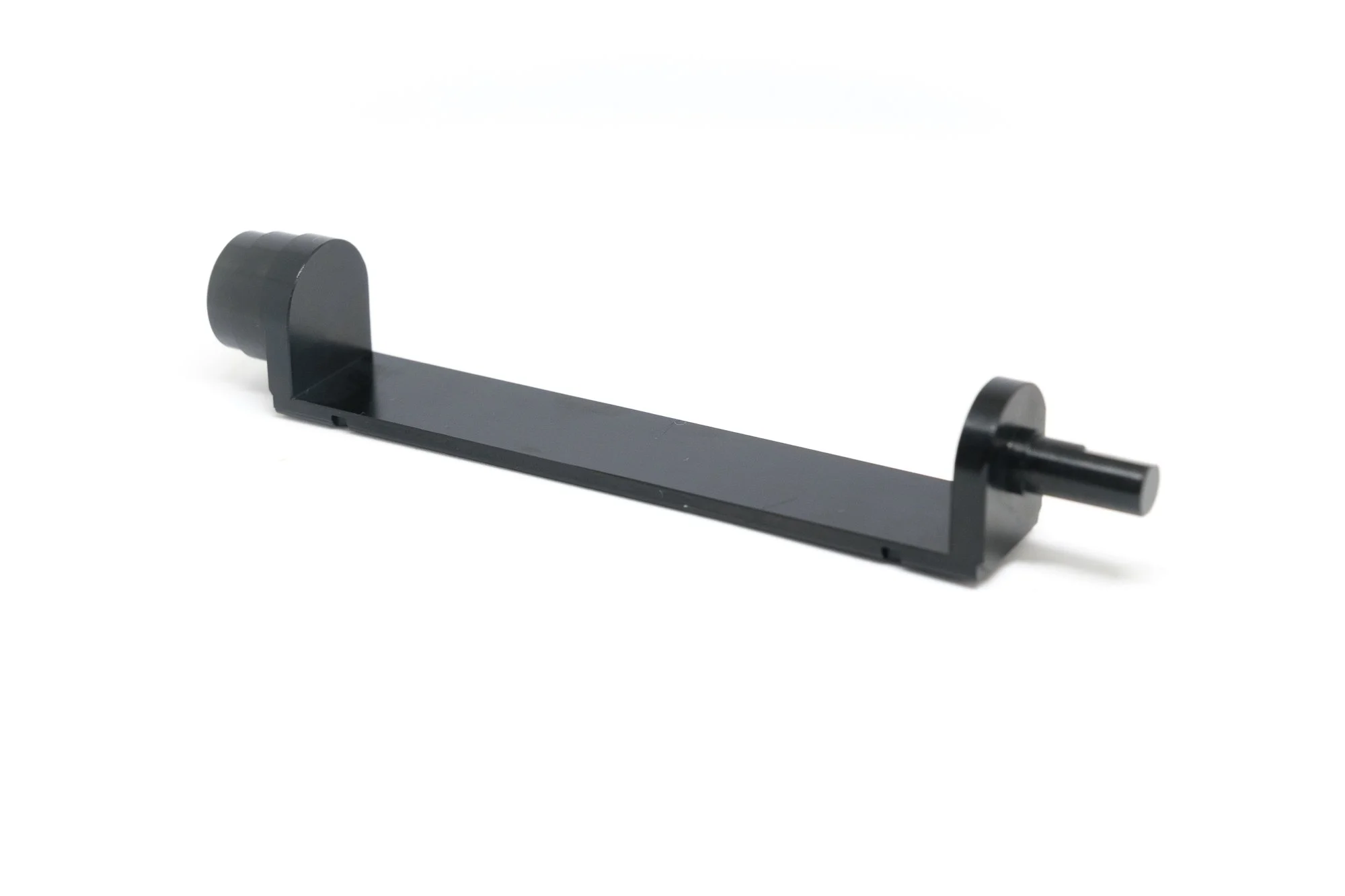 A black, L-shaped metal bracket with a cylindrical peg on one end and a rounded opening on the other, isolated on a white background.