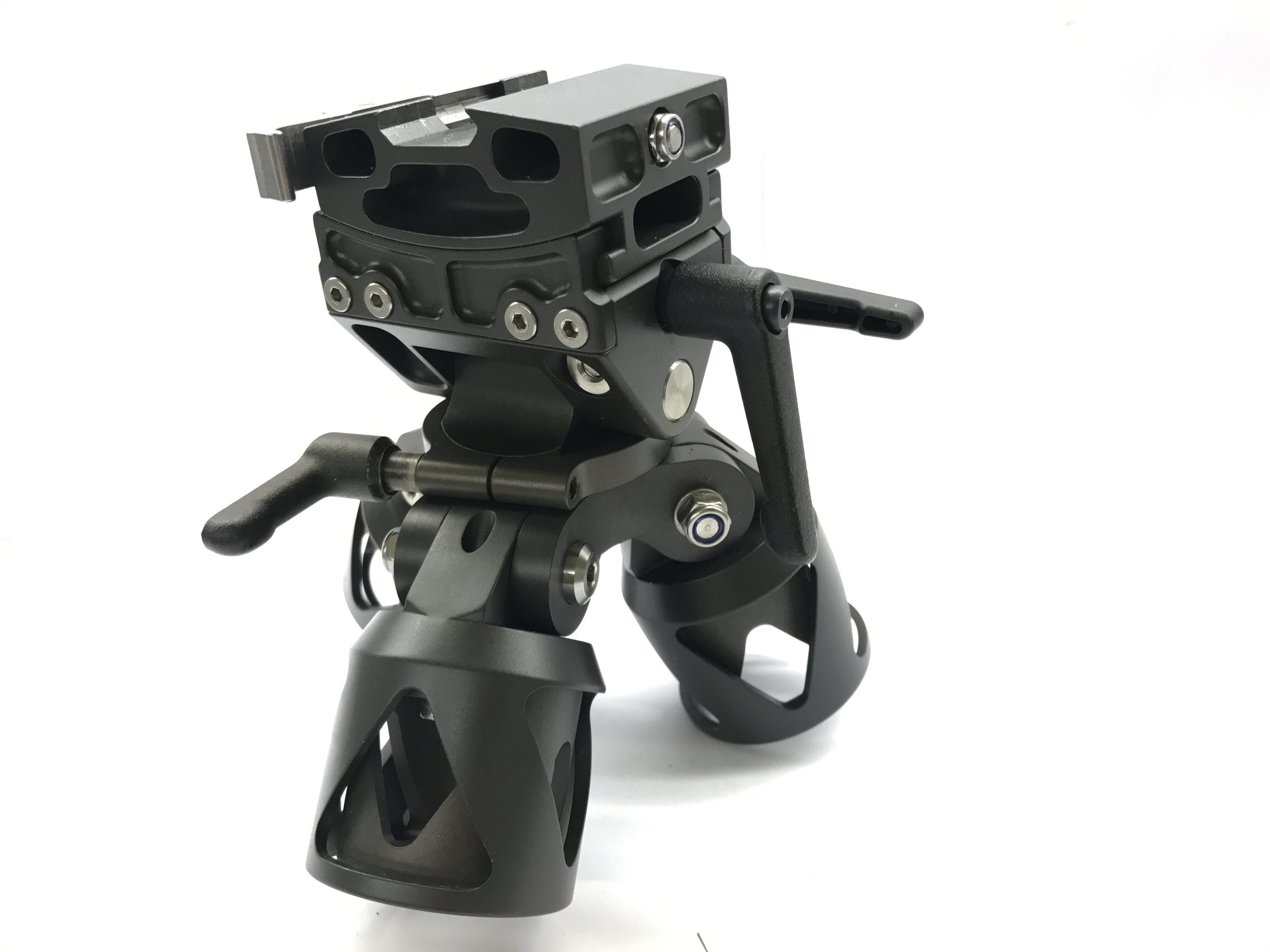 Close-up of a professional camera stabilizer or gimbal used for filming, with a black metal and plastic construction and ergonomic handles.