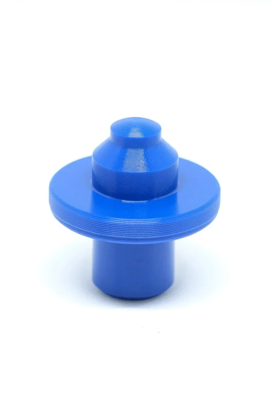 A blue plastic nozzle with a wide, flat, circular base and a conical top.