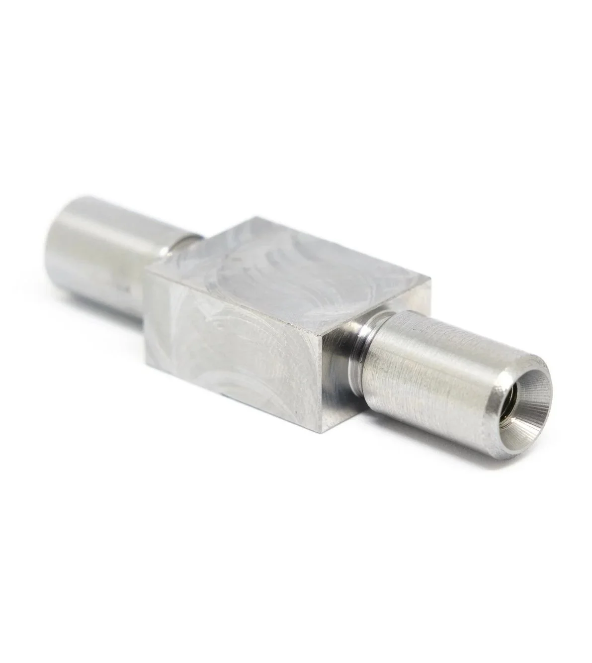 Close-up of a metallic mechanical component with cylindrical ends and a rectangular middle section.