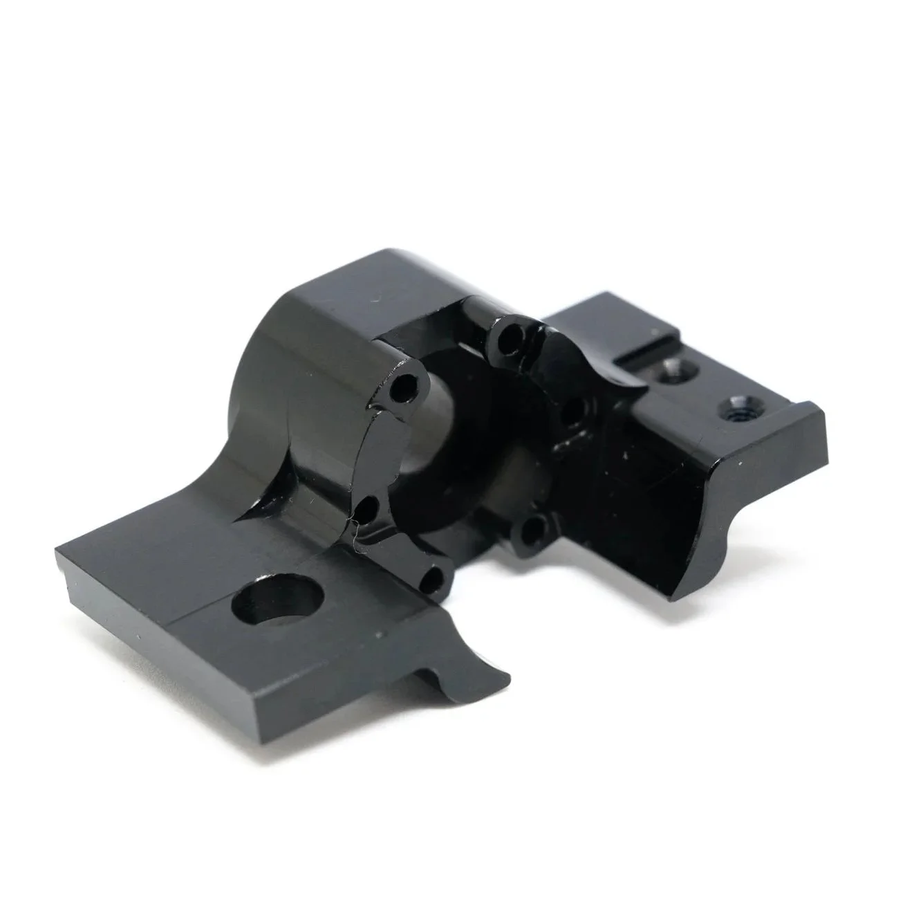 Black metal mechanical component with multiple holes and mounting points.