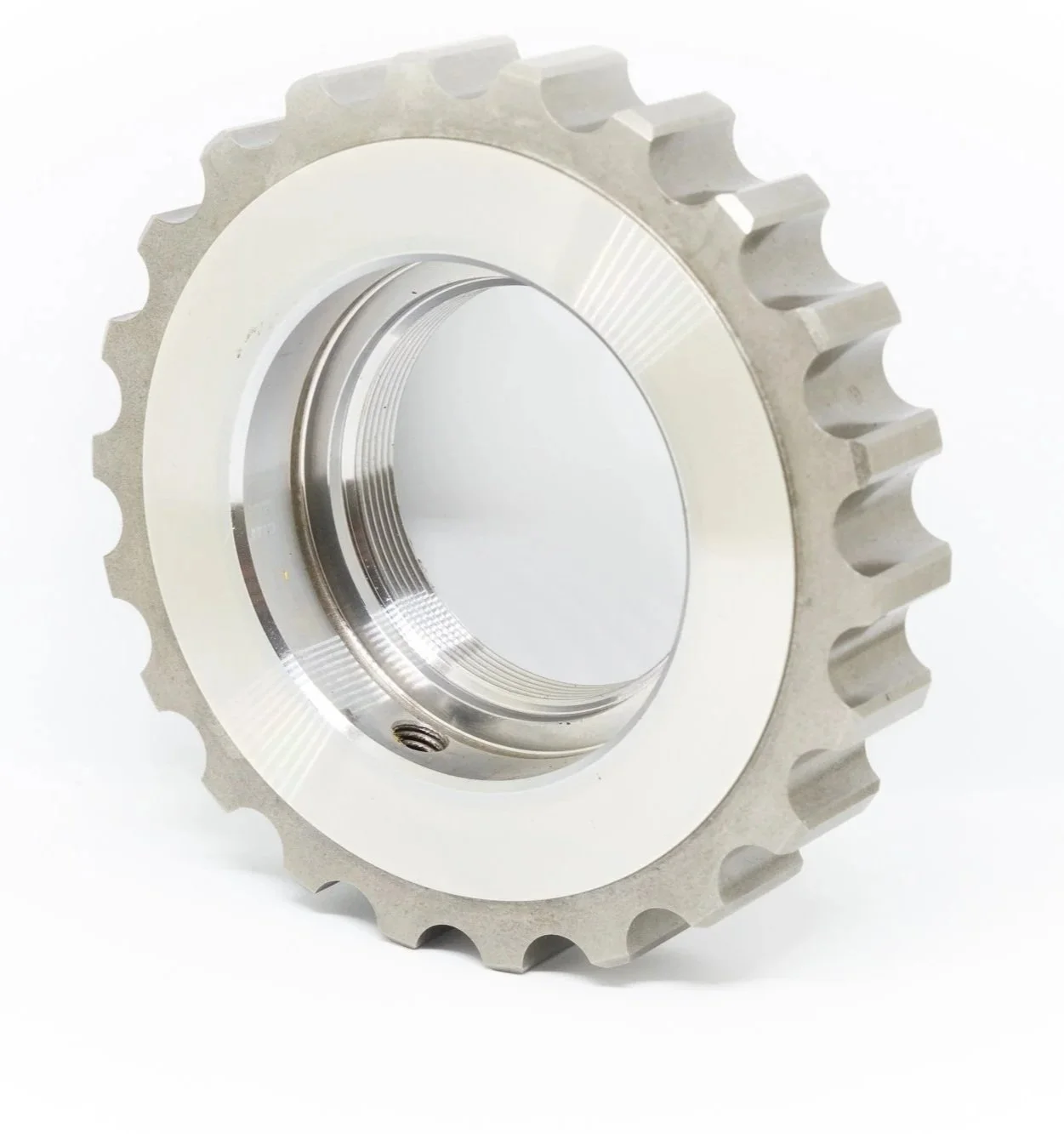 A metal gear with teeth on its outer edge and a smooth inner surface, isolated on a white background.