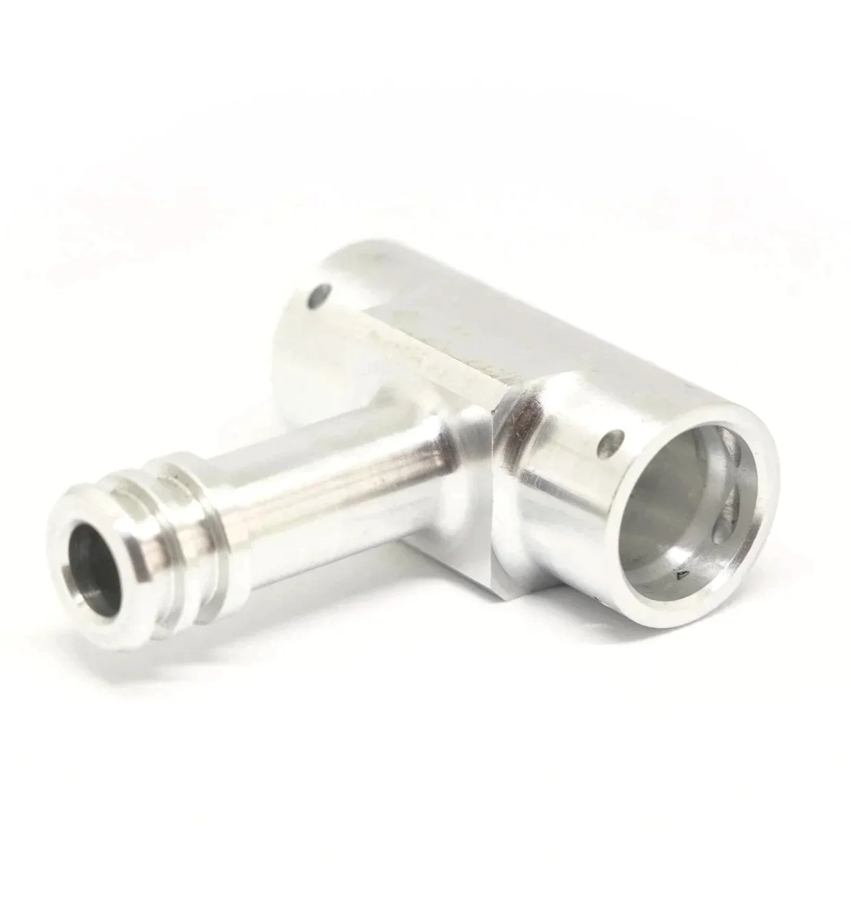 Silver metallic mechanical component with cylindrical and tubular sections, likely part of a machine or engine.