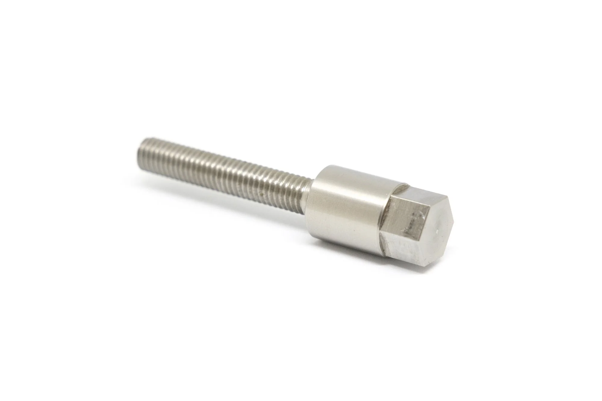 Metal bolt with threaded shaft and hexagonal head against a white background.