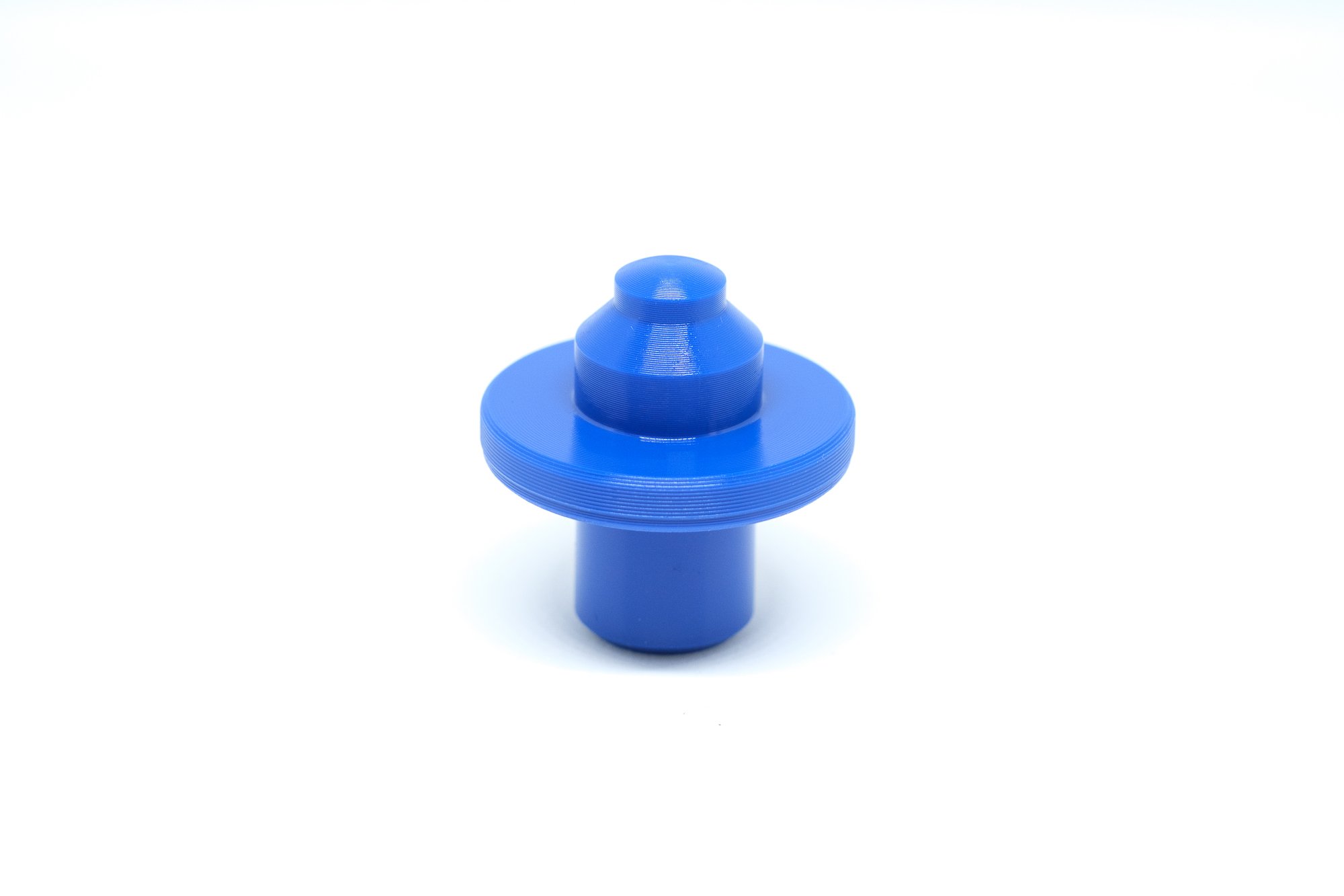 Blue 3D-printed spiral object on a white background.