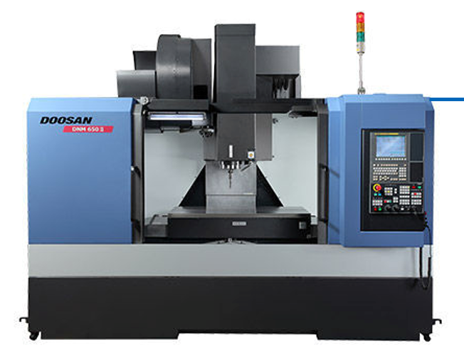 Industrial computer-controlled machining center, blue and gray, with control panel and indicator lights