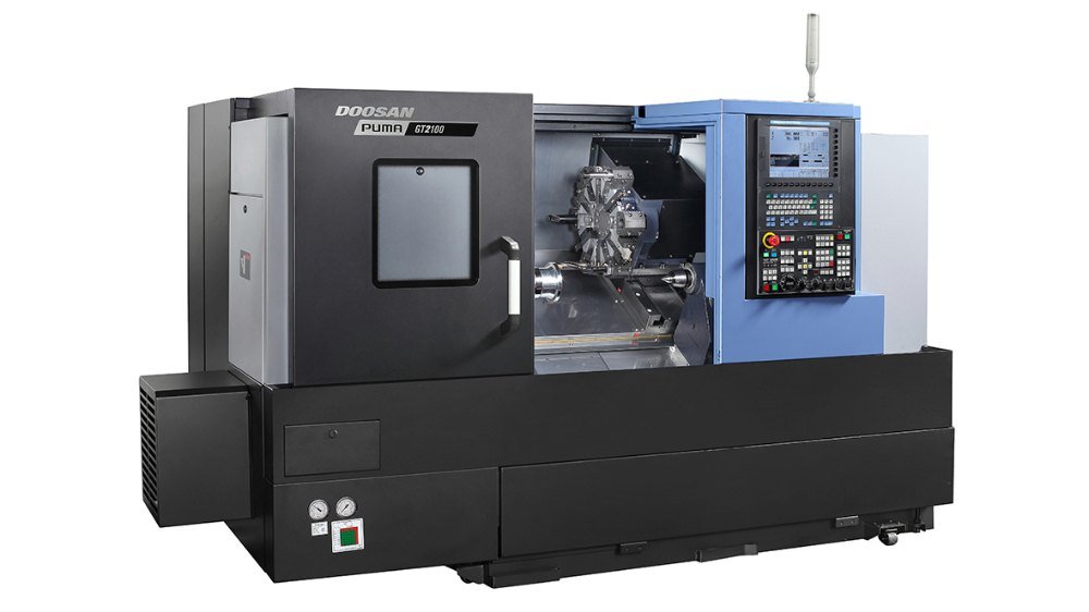 A CNC machining center with a control panel on the right and a enclosed work area.