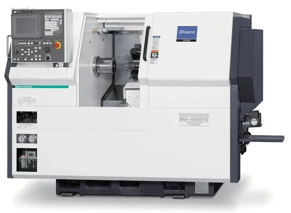 A white CNC lathe machine with control panel on top left, labeled 'Miyano' and 'Citizen', used for precision metalworking.