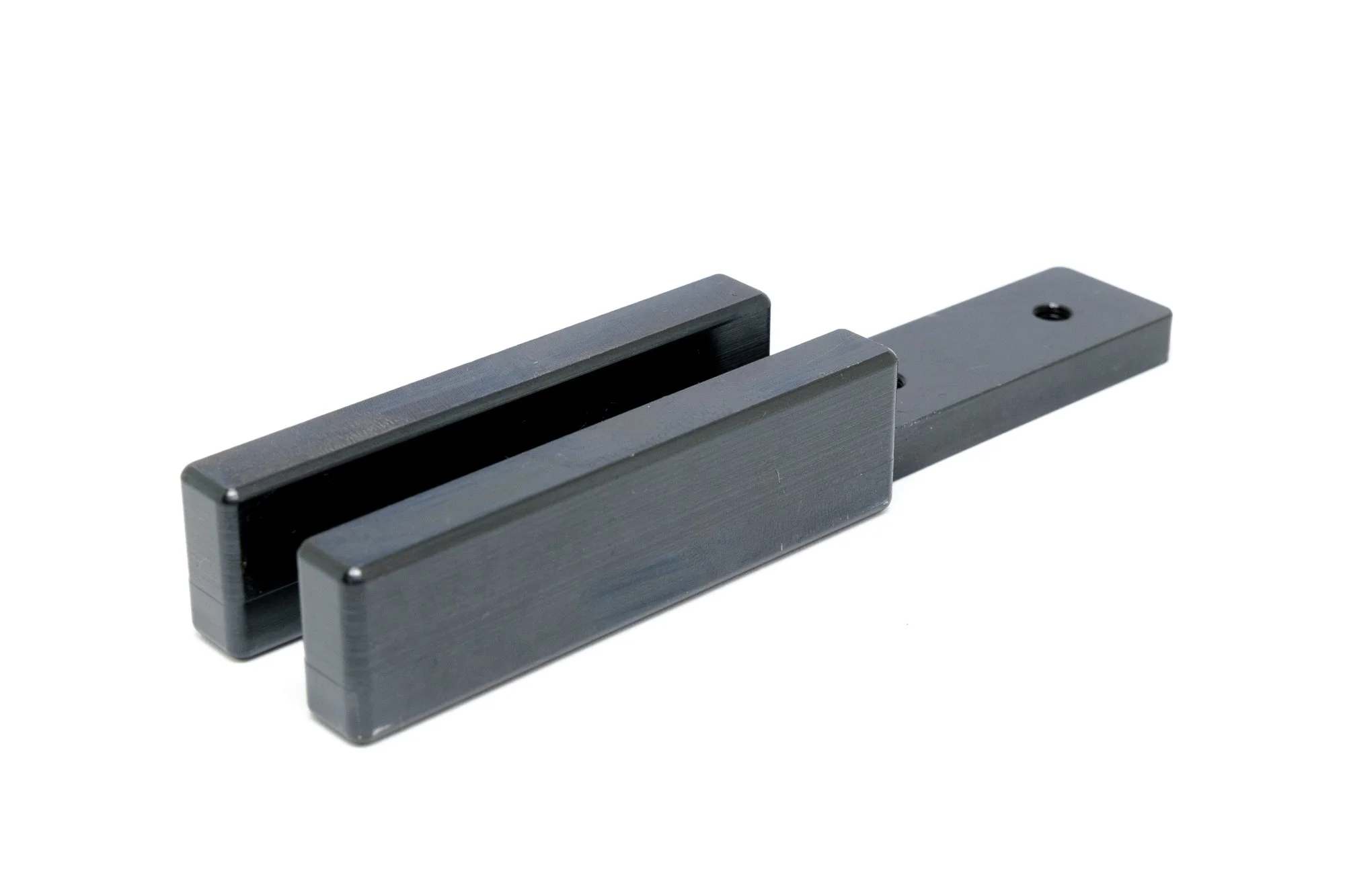 A black metal sliding door bolt latch on a white background.