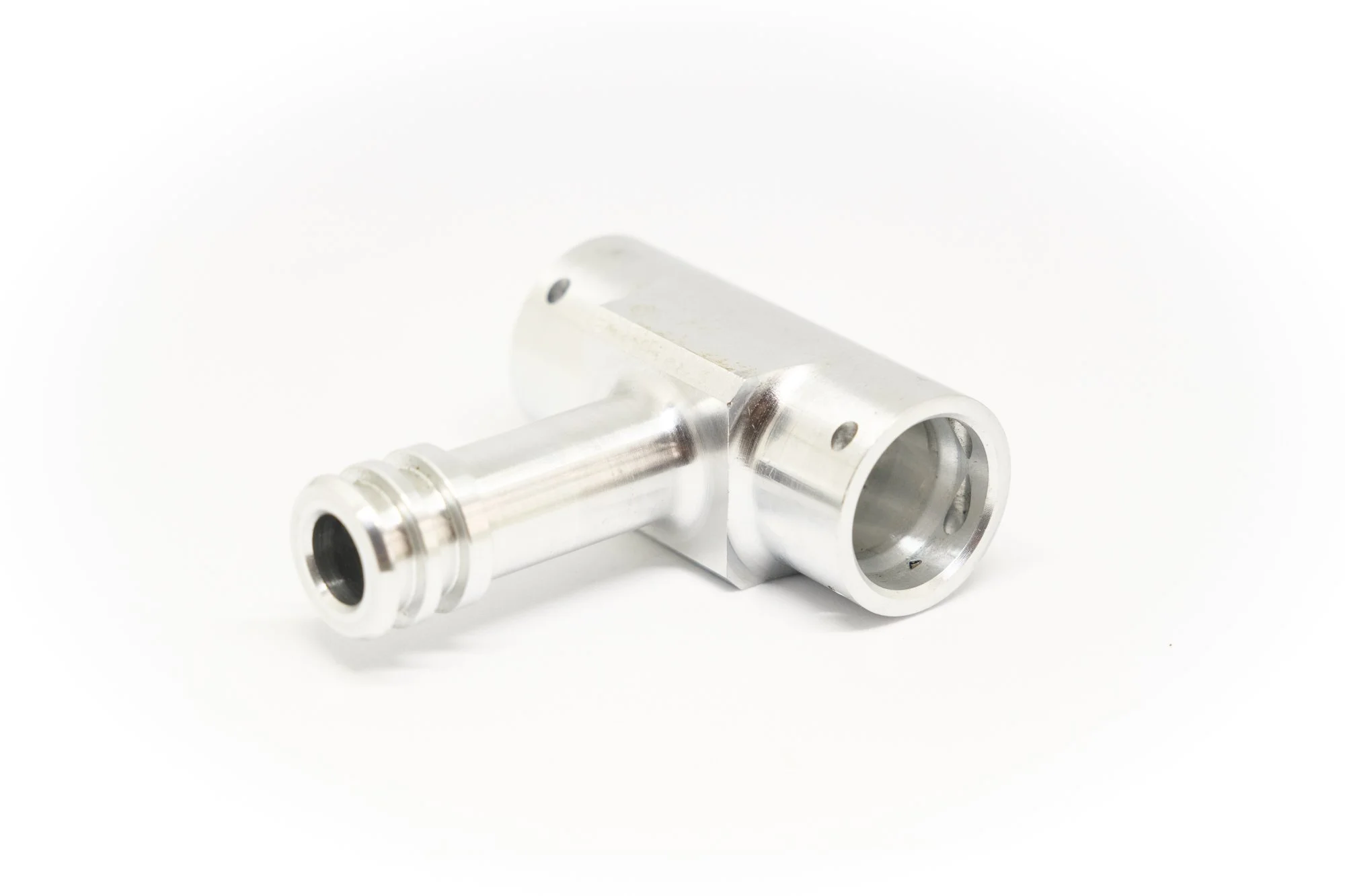 A metallic drill chuck with a cylindrical attachment, likely used for machining or manufacturing purposes, placed on a white background.