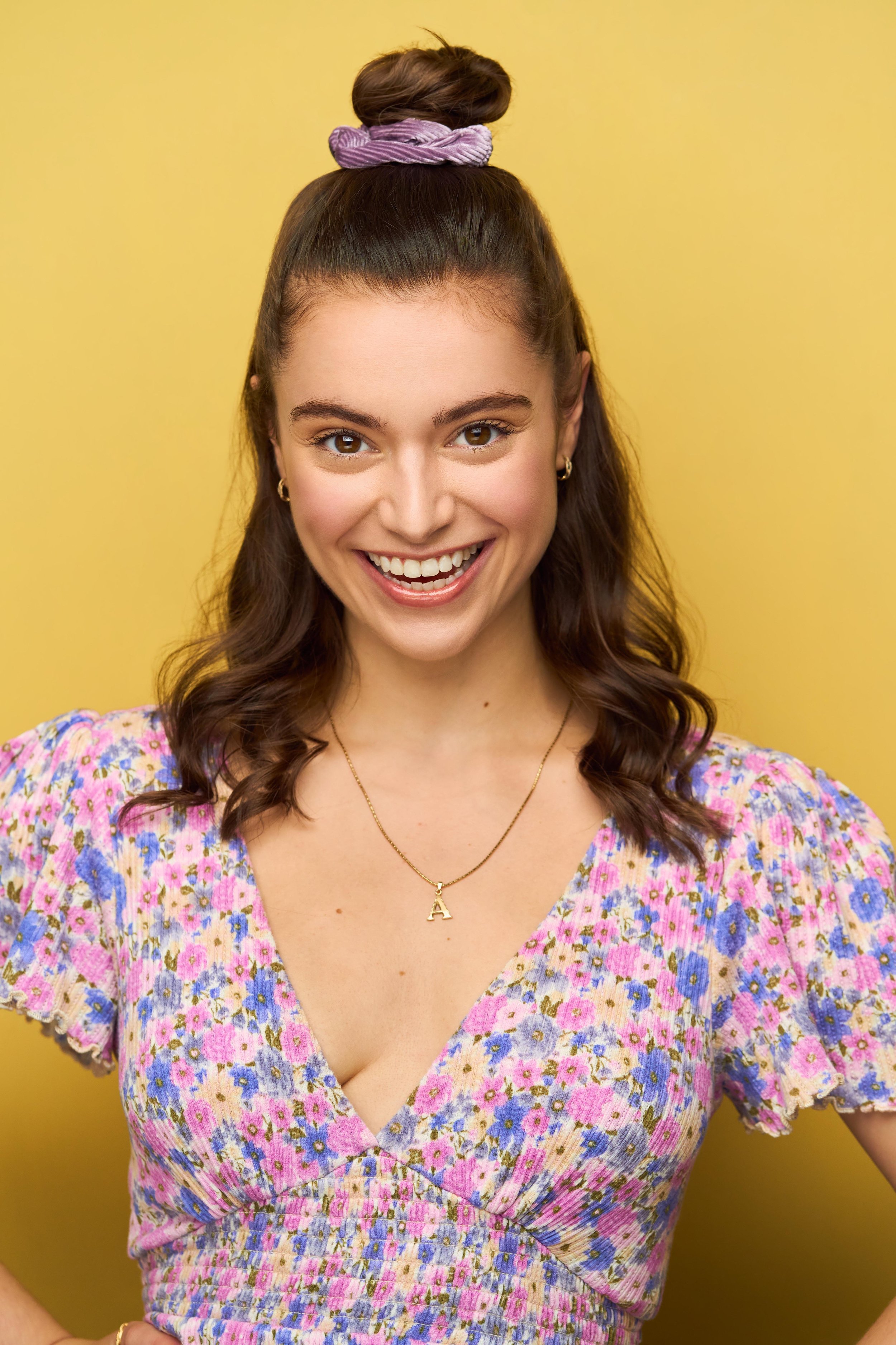 Alexandra Tarsinov Headshot Yellow.jpg