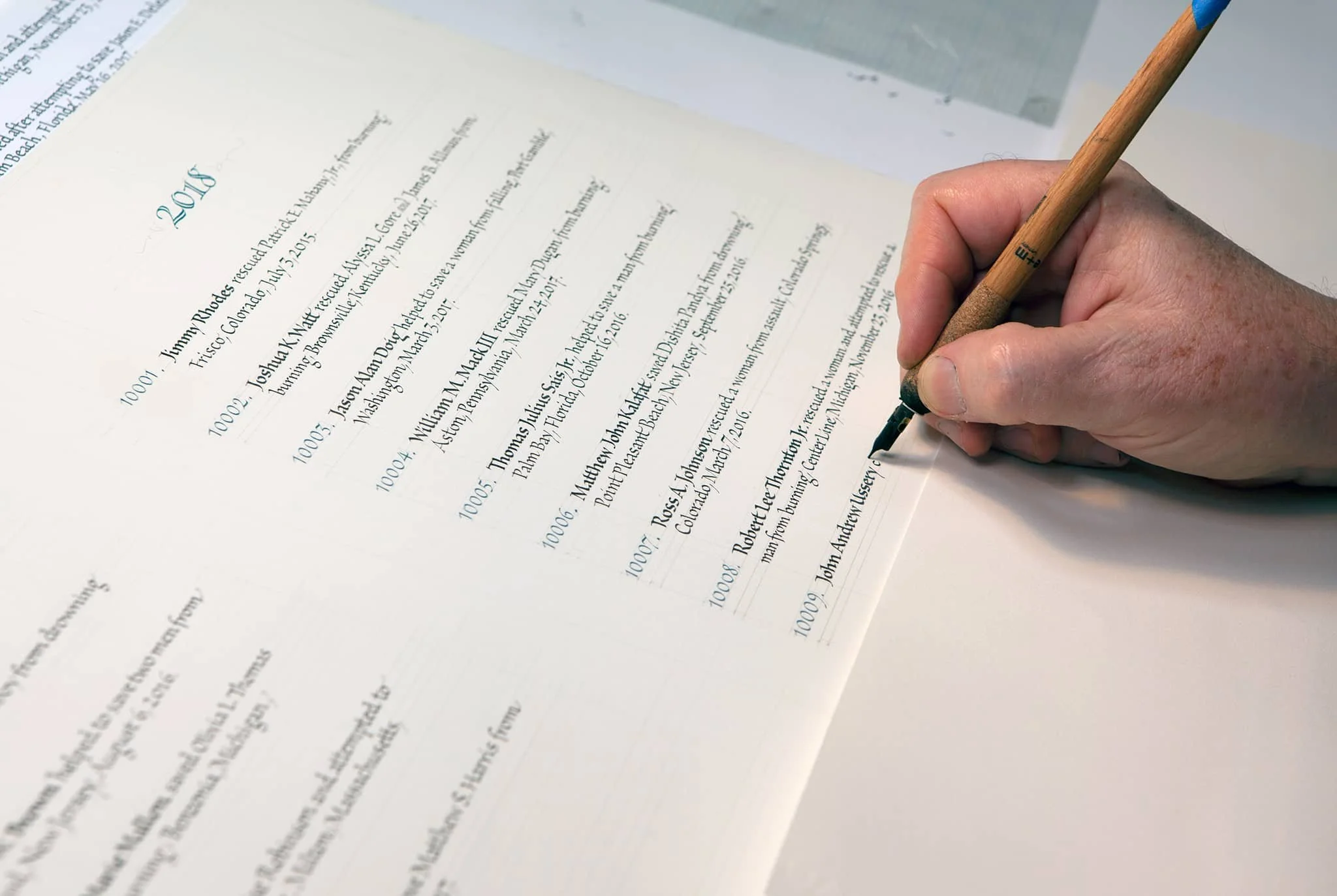 Design & Calligraphy by John Stevens. Pen calligraphy; writing the names in a book of honor.