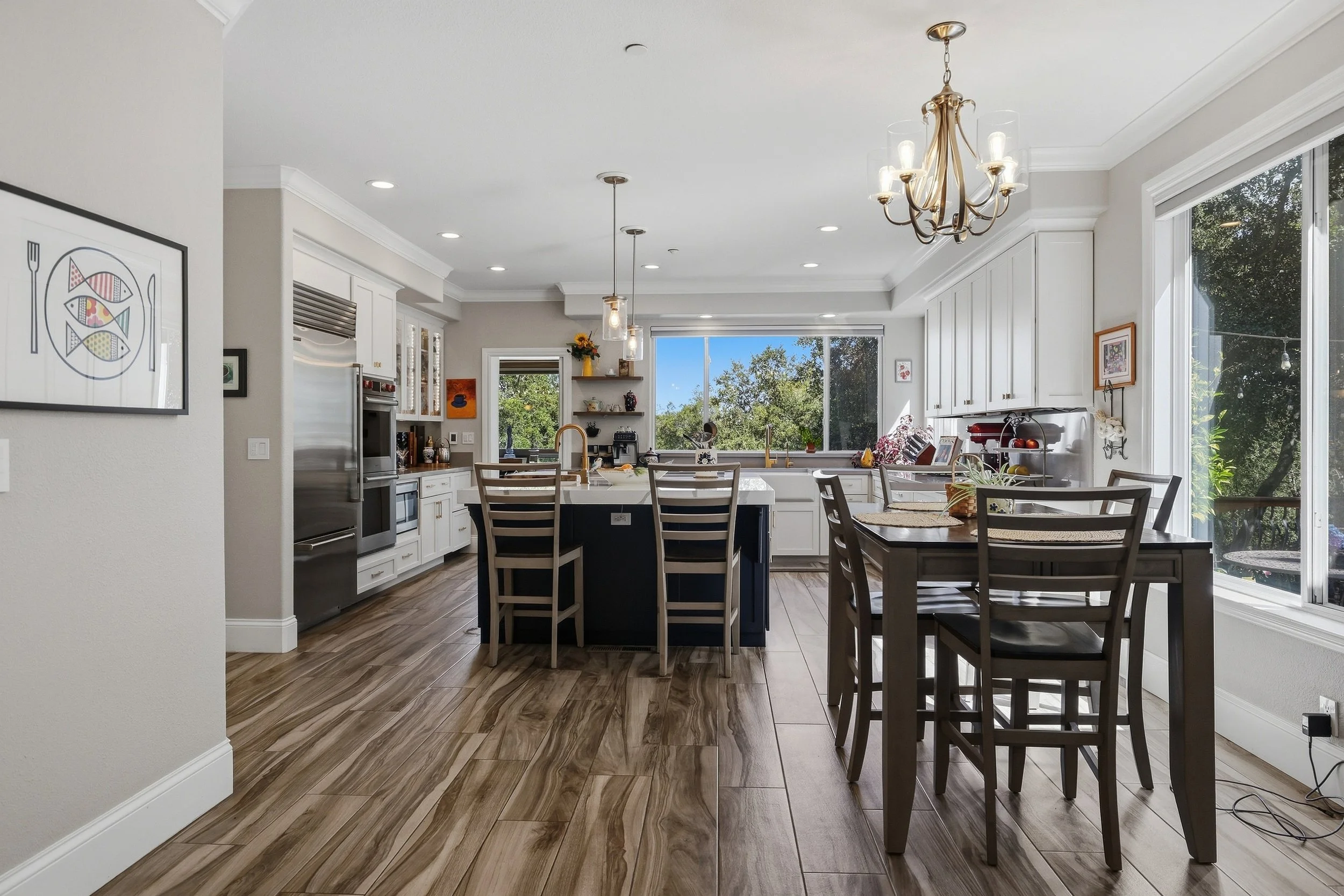 Open kitchen and dining space with island seating and views outdoors.