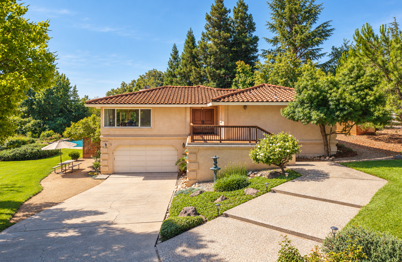 Front exterior view of a single-story house with a tiled roof, a double door entry, and a driveway leading to an attached garage, surrounded by trees, grass, and landscaped yard.