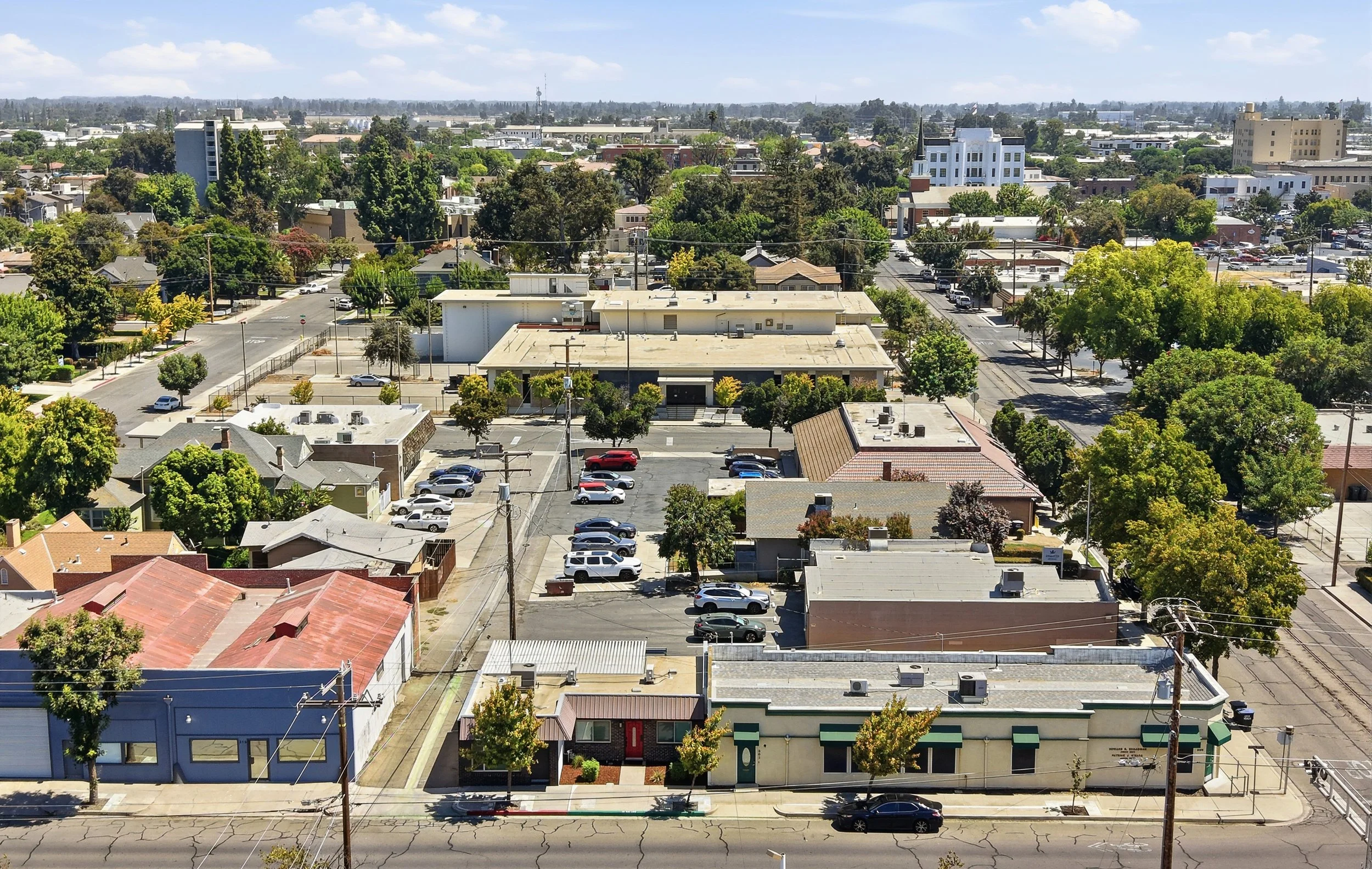 Aerial view of a Visalia commercial neighborhood with streets and nearby buildings.