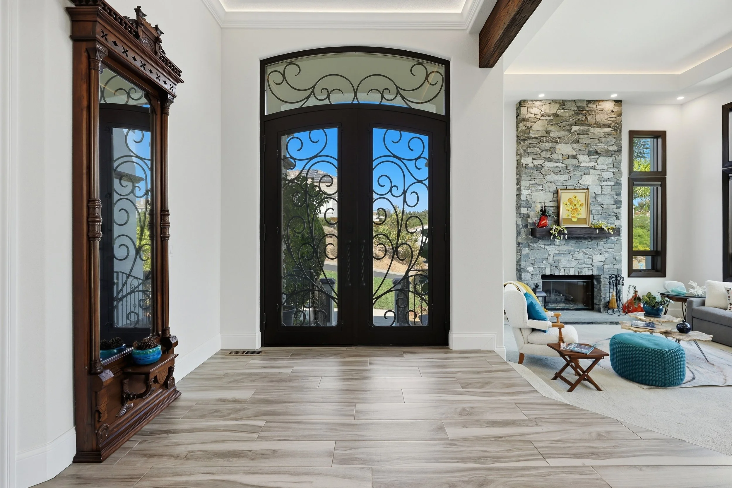 Decorative double front doors beneath an arched transom window.