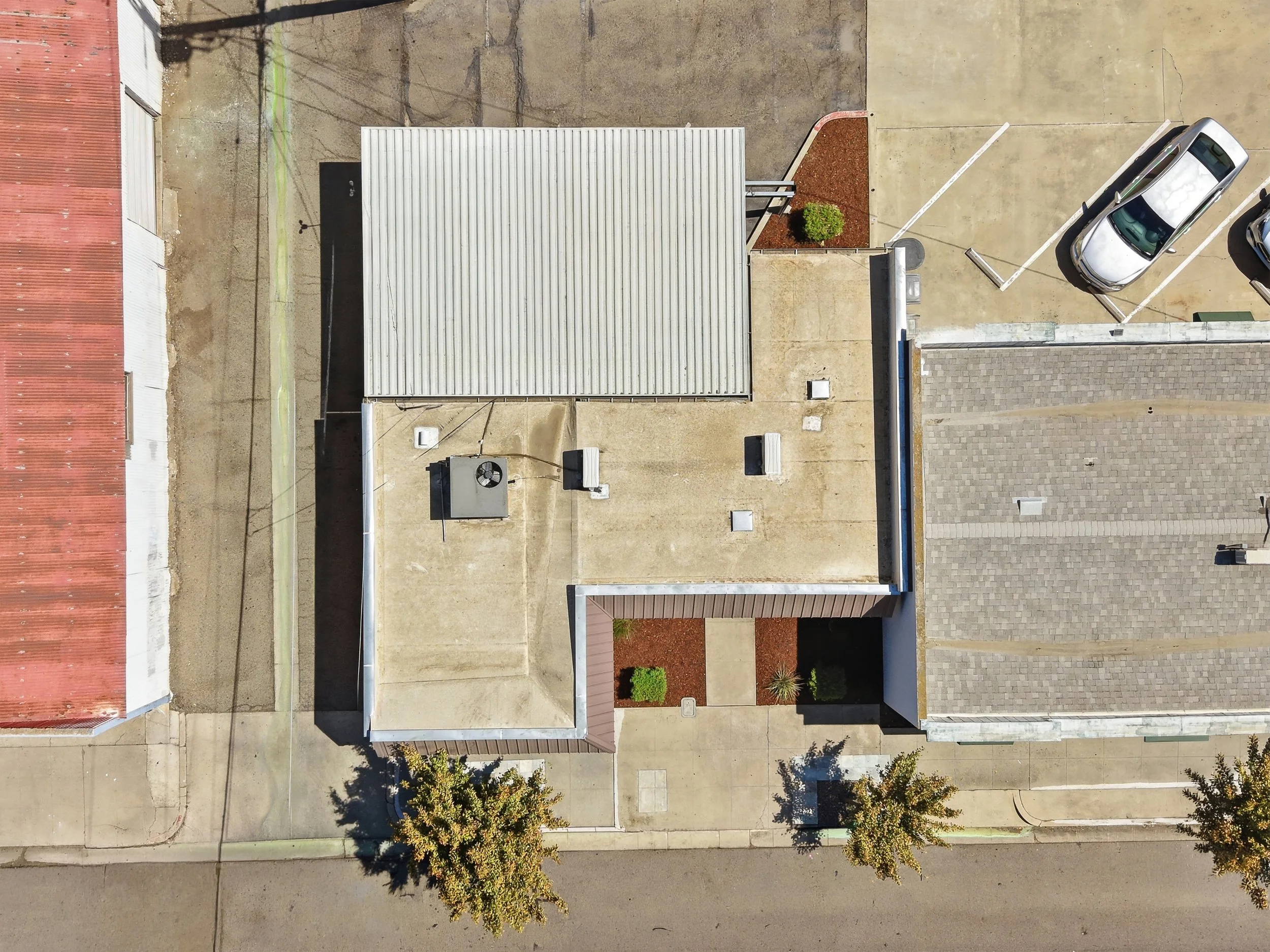 Overhead aerial view of a commercial property and its roof layout.