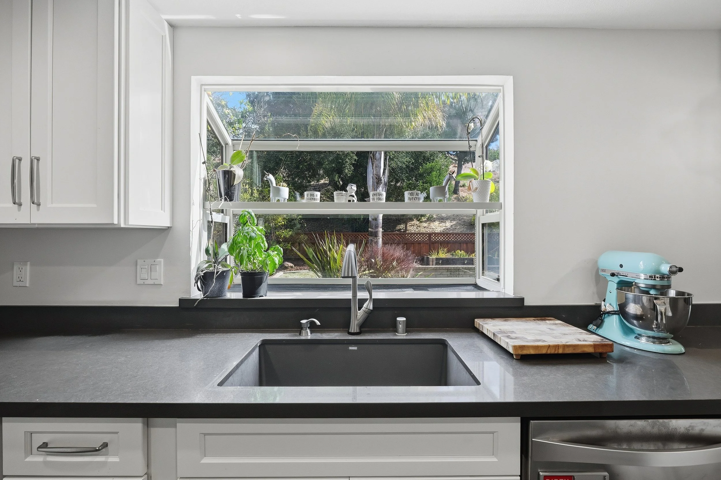 Double kitchen sink beneath a window overlooking the garden.