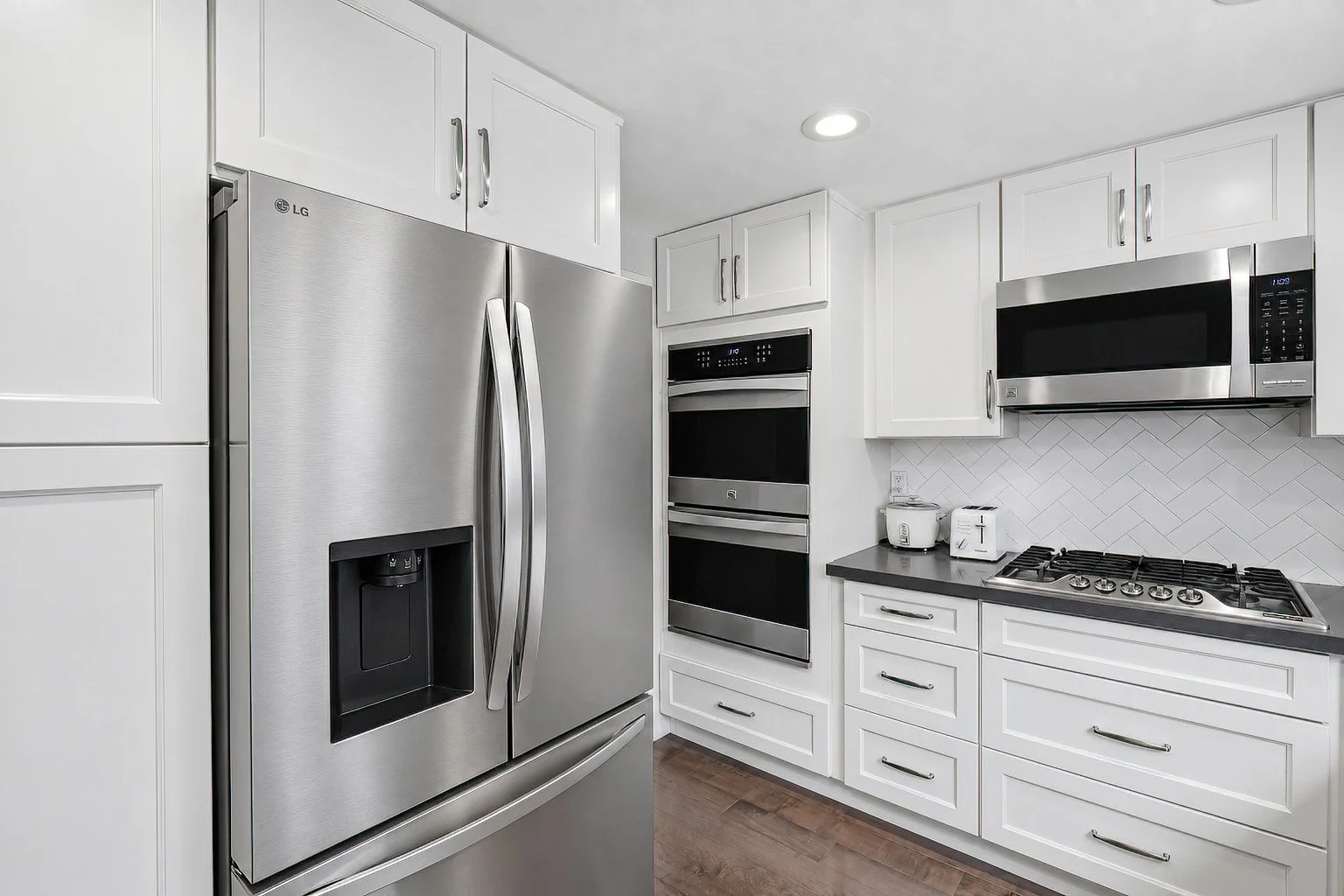 Kitchen with stainless-steel refrigerator and built-in wall ovens.