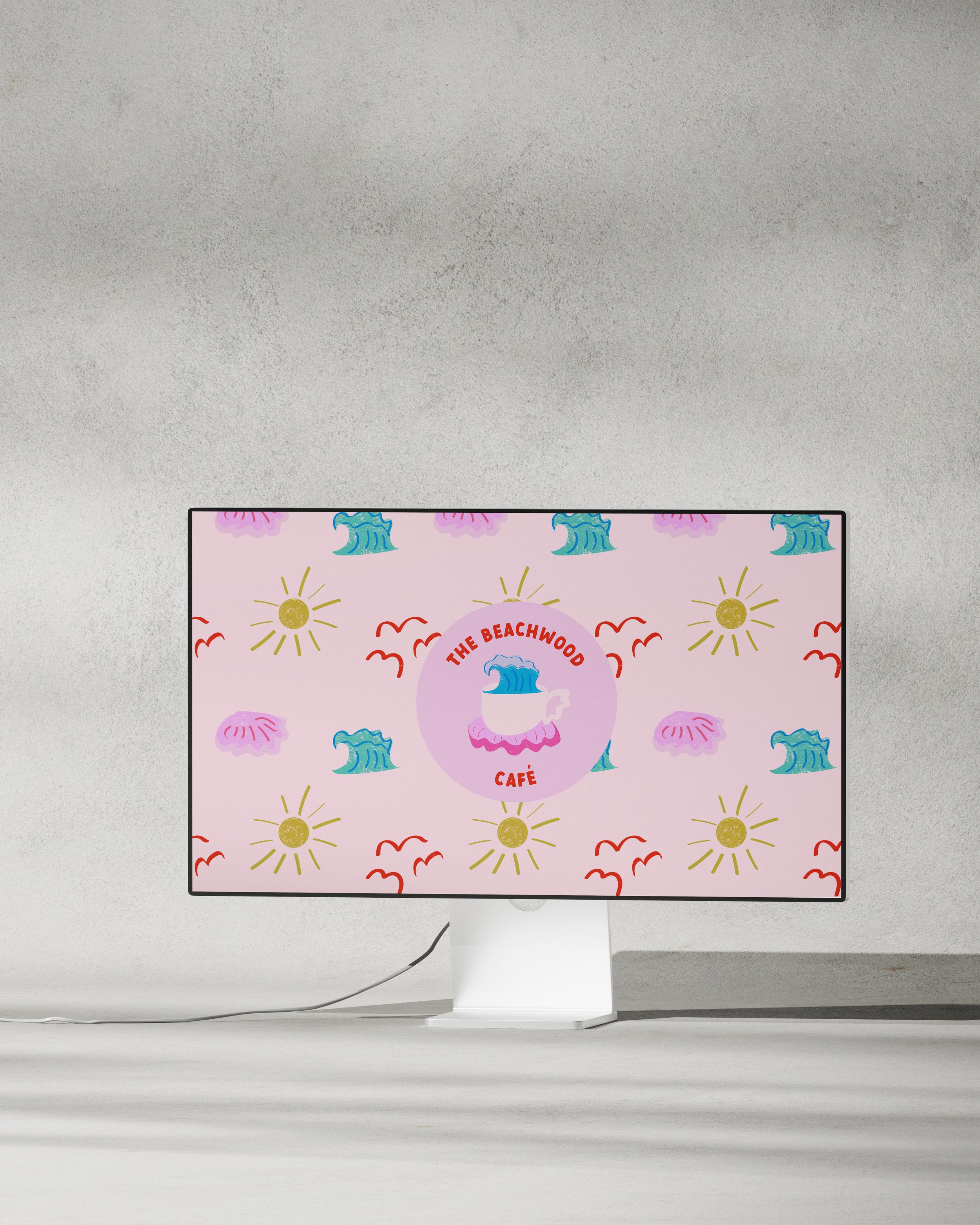 Computer monitor displaying a logo for The Beachwood Café featuring a cup with a wave inside, surrounded by a pink circle, with a background of pink, yellow, blue, and red abstract patterns including suns, waves, and seagulls.