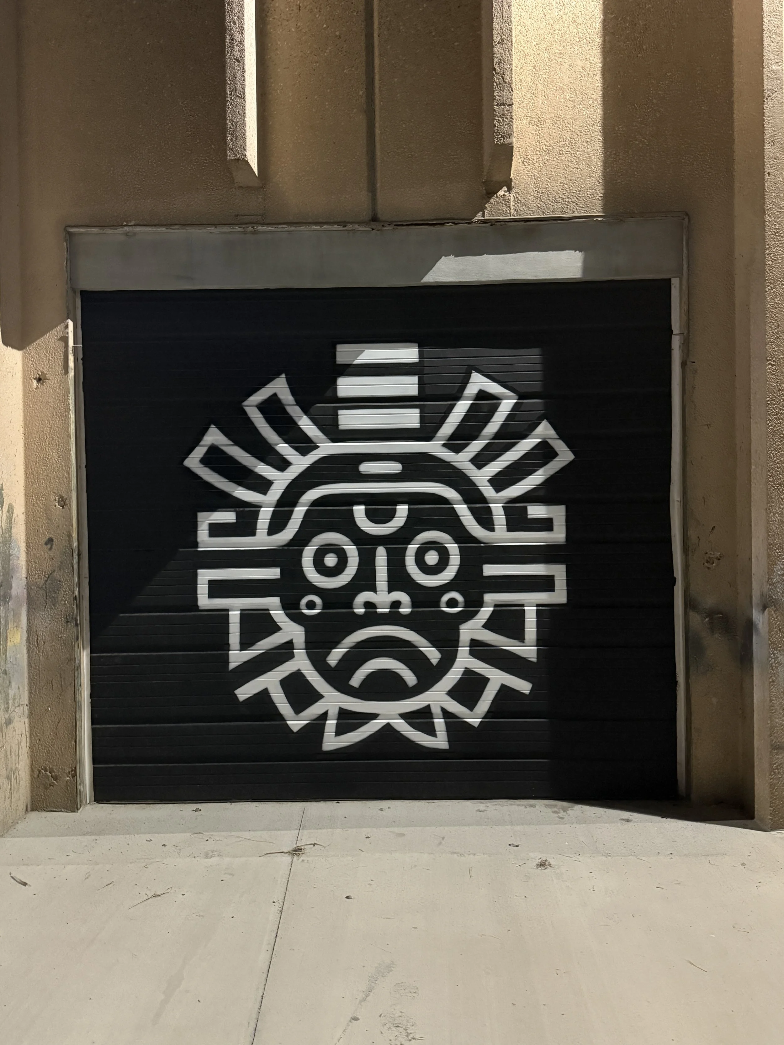 Designed by my friend Clayton Dahm and spray painted by me onto the front gate, this large Combat Warriors logo became one of the main visual markers for our gym. Since the space is tucked away from the road, the gate helps people spot us from a dist