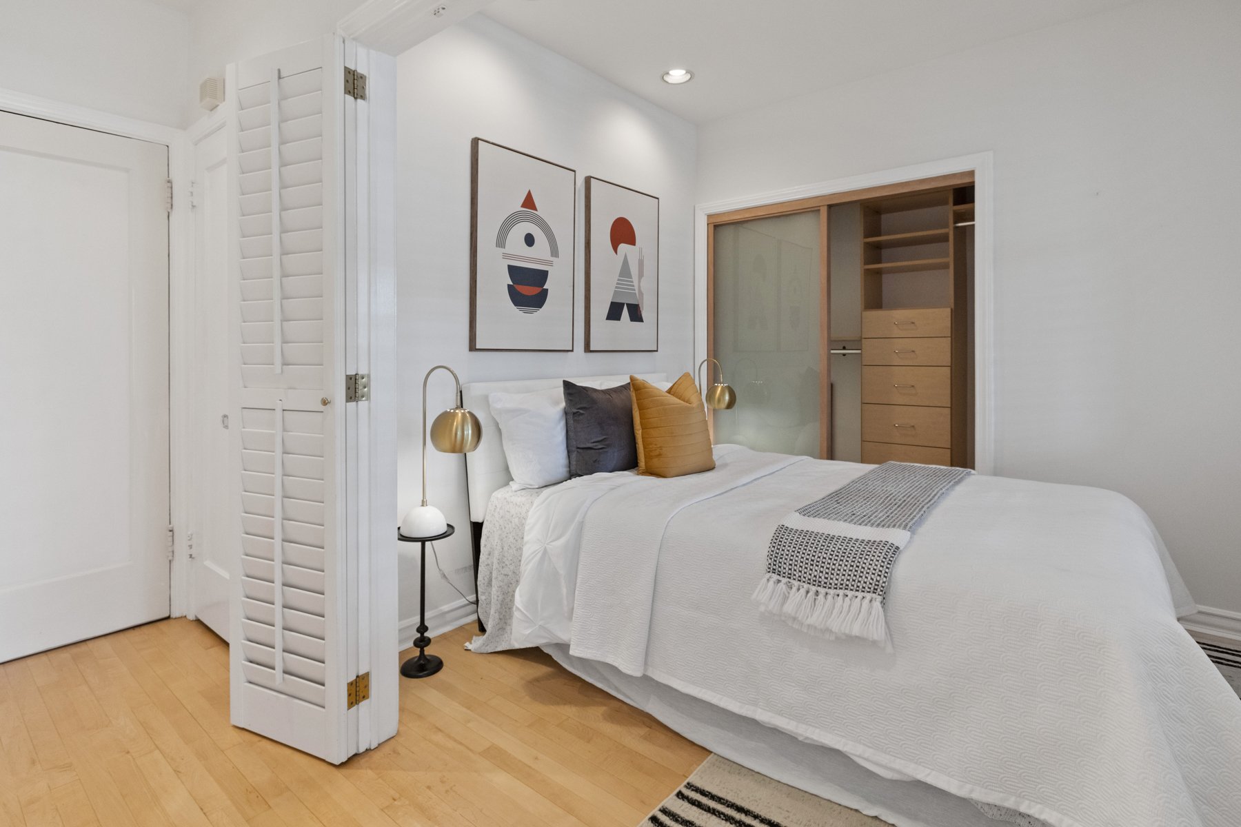 Real estate picture showing a bedroom with a white bed.