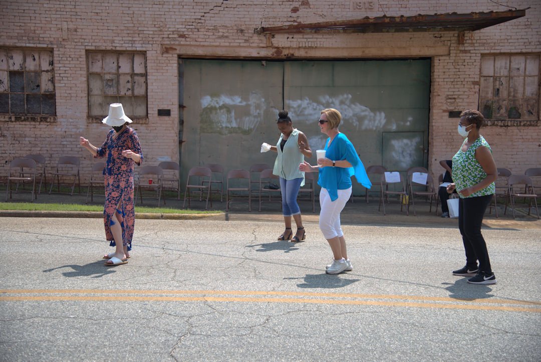 Community members enjoy the event surrounding the mural dedication (2021)