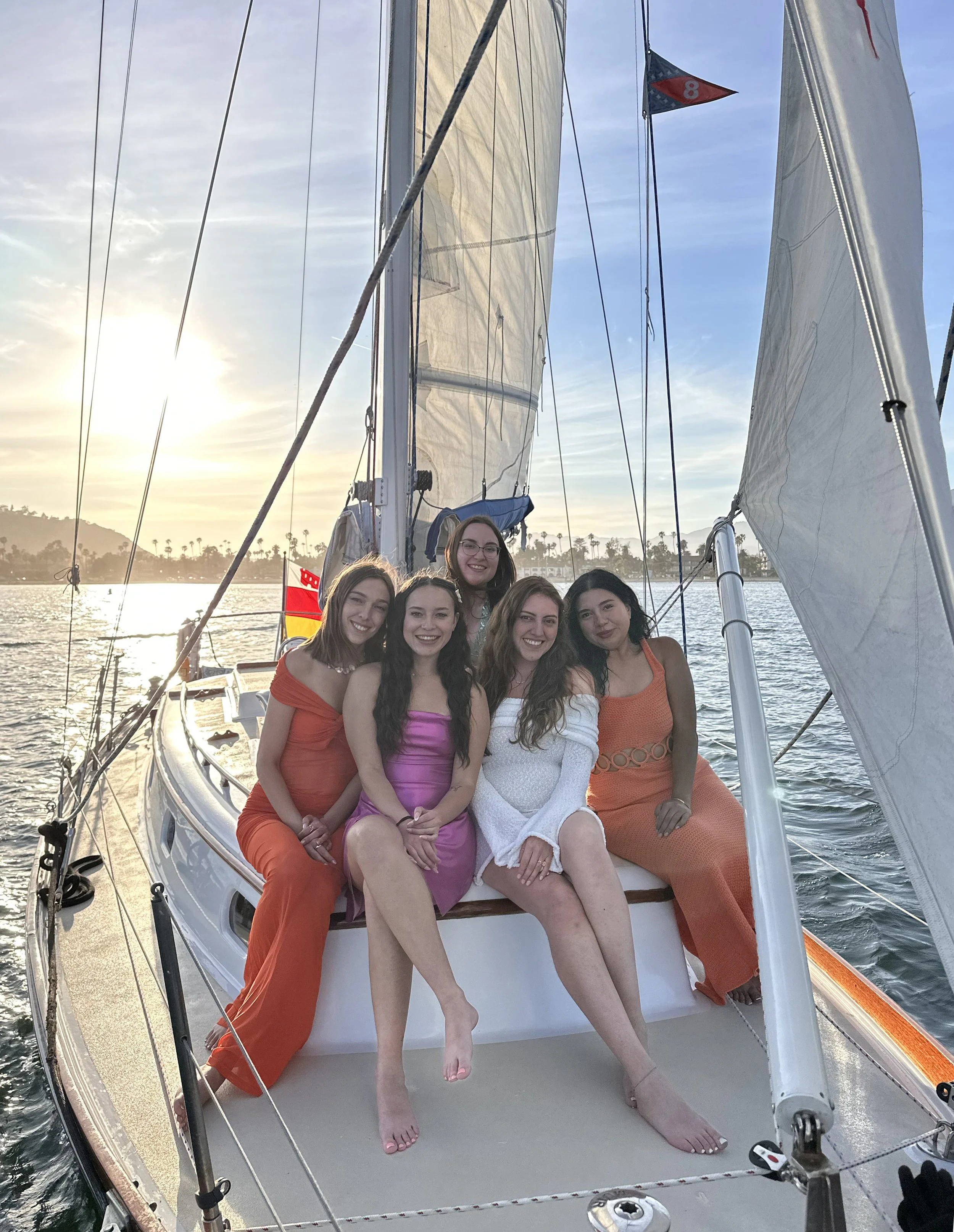 Four women enjoying the bow of Kelpie during a private sunset sail in Santa Barbara.