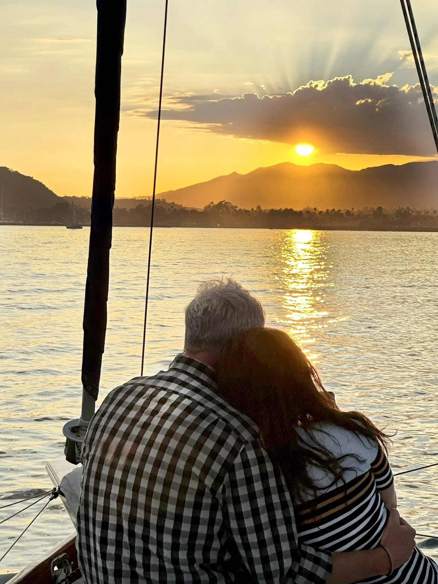 Couple watching the sunset aboard Kelpie during a private Santa Barbara sunset sail.