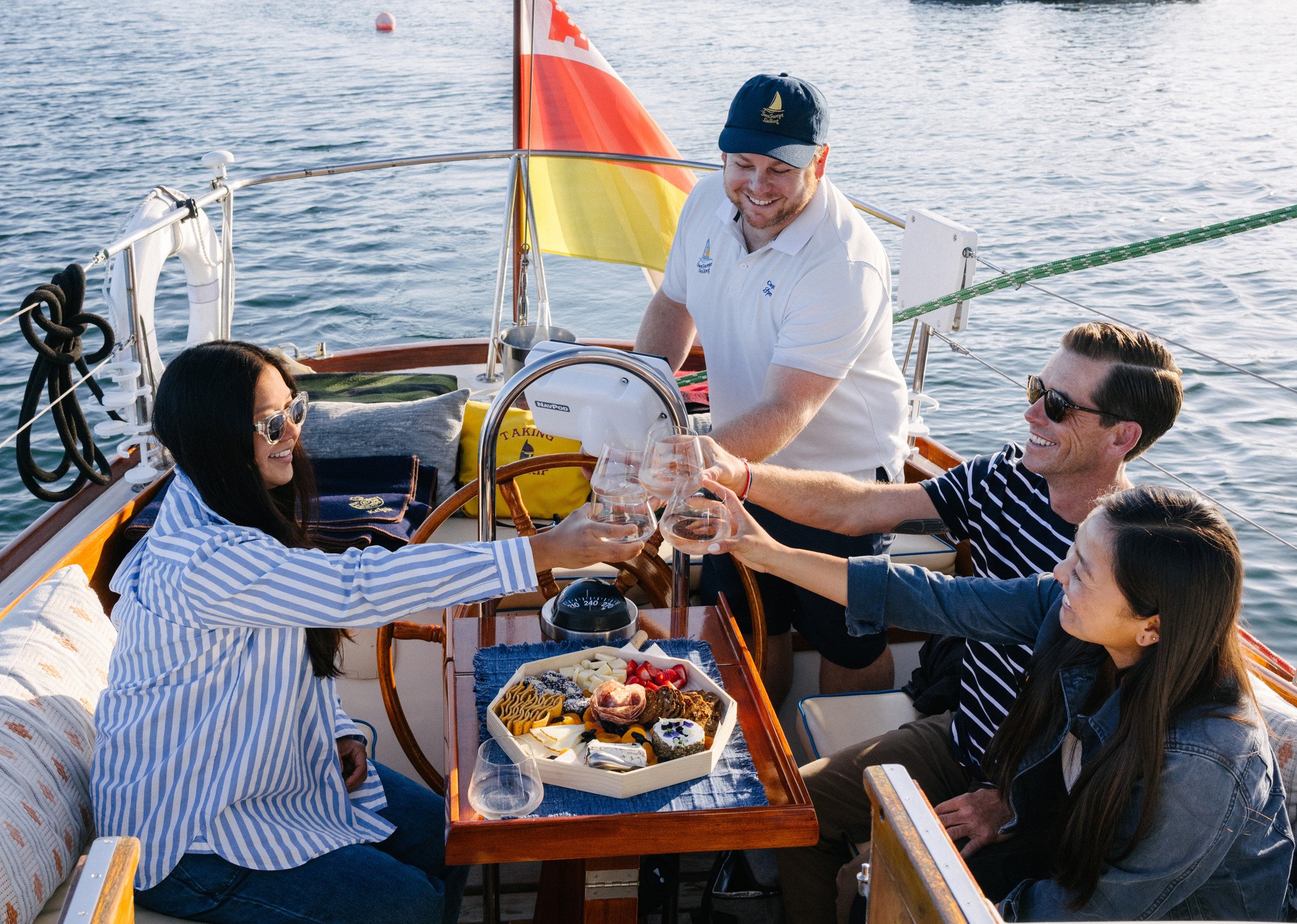 Guests enjoying gourmet charcuterie and local wine aboard a private sailing charter in Santa Barbara.