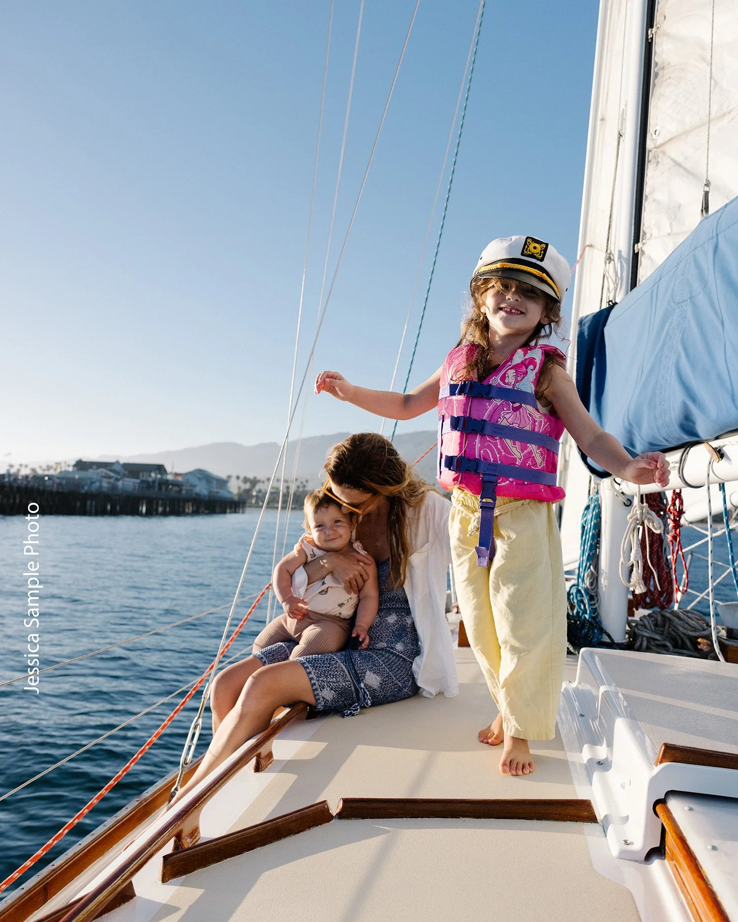 Mother and two young children aboard Kelpie during a private family cruise in Santa Barbara Harbor.