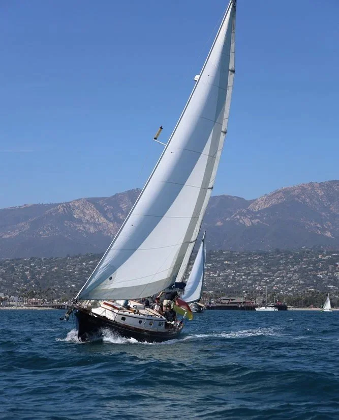 Yacht Kelpie sailing under full sail off the Santa Barbara coastline.
