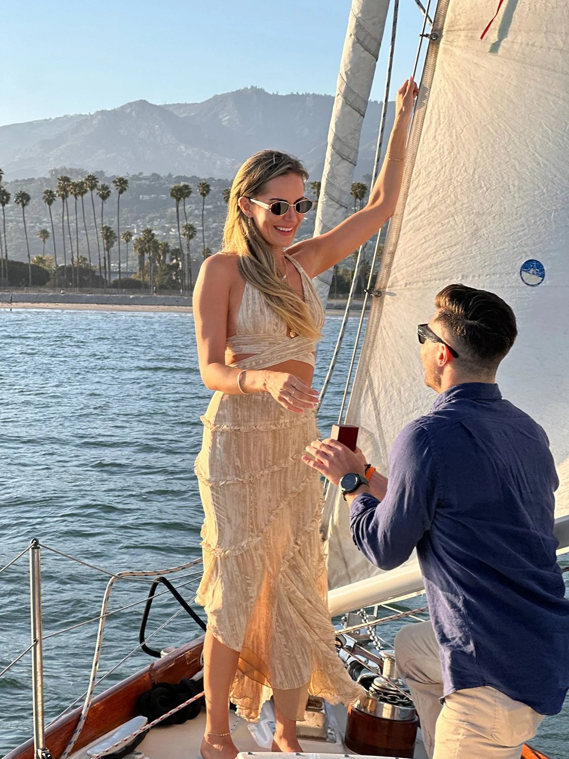 Man proposing aboard Yacht Kelpie during a private sailing charter in Santa Barbara.