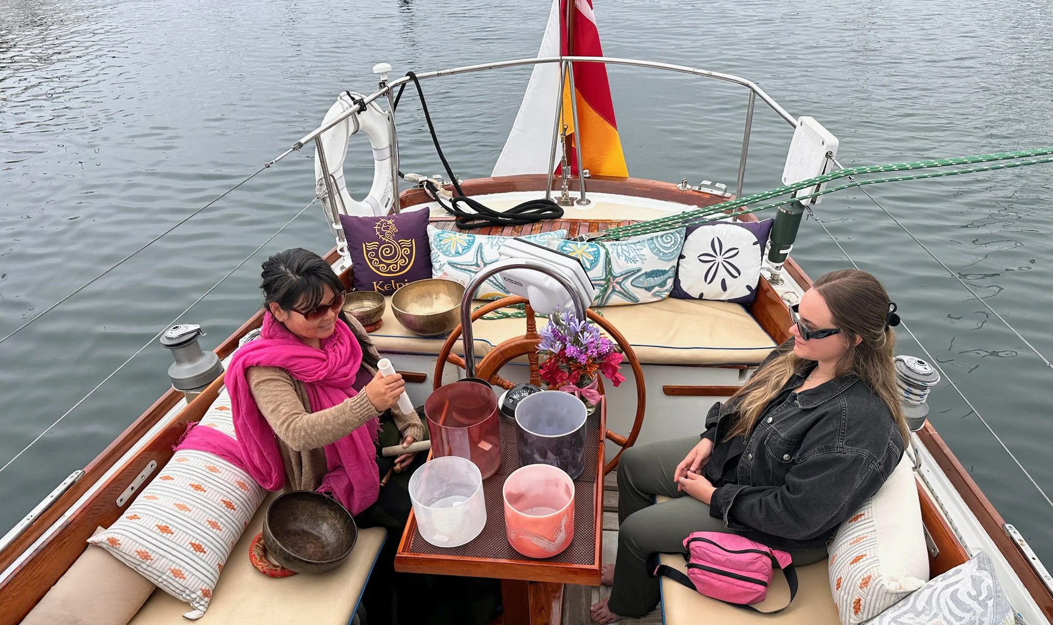Certified Sound Practitioner guiding a guest during a private Sound Bath Sail aboard yacht Kelpie in Santa Barbara.  ⸻