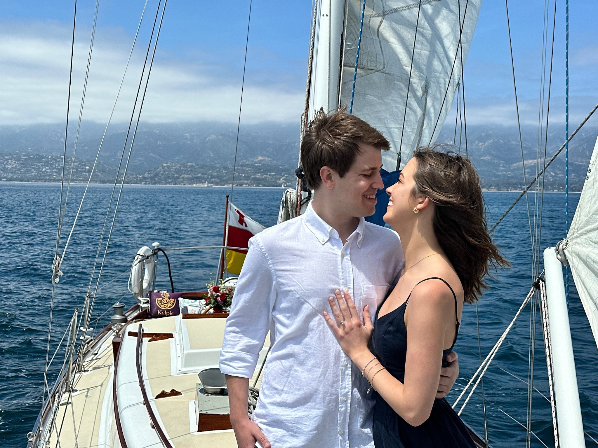 Couple enjoying a private proposal sailing experience aboard Yacht Kelpie.