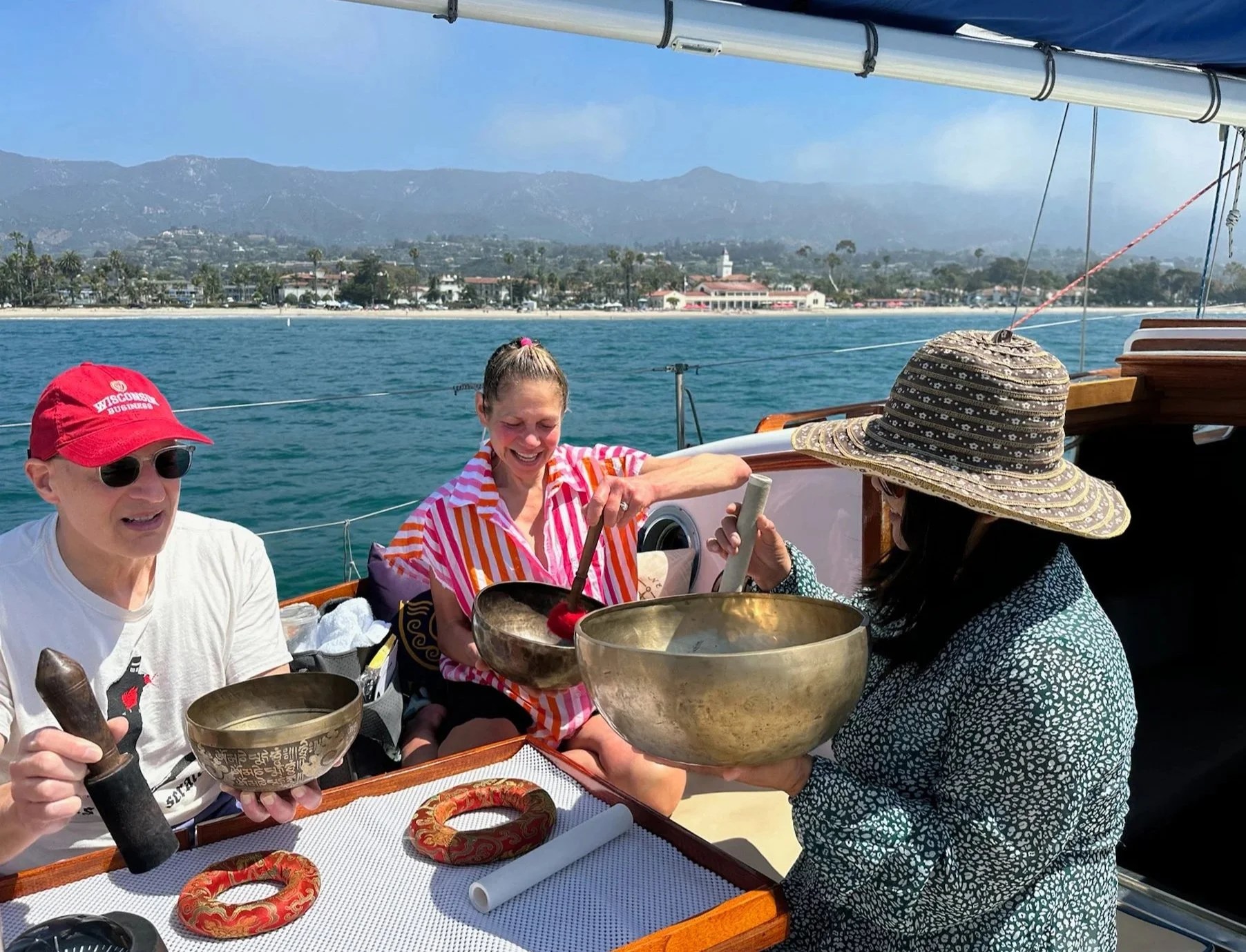 Small group participating in a private Sound Bath Sail with singing bowls aboard yacht Kelpie in Santa Barbara.