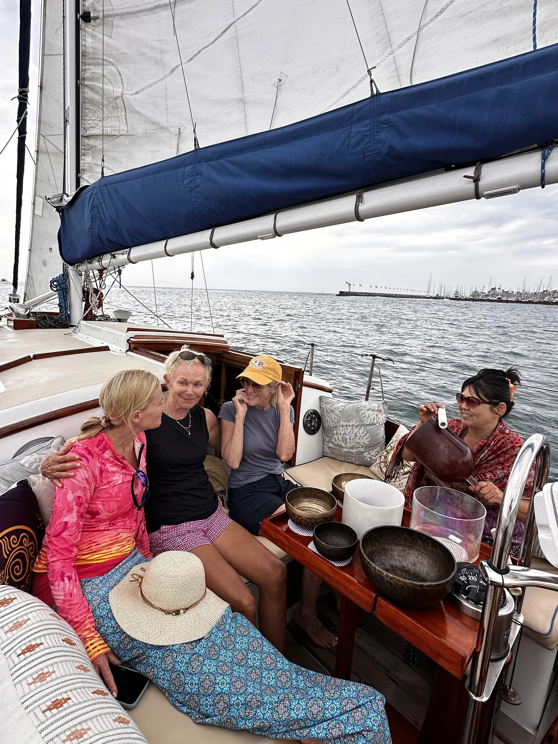 Guests enjoying a guided Sound Bath with singing bowls aboard yacht Kelpie during a private Santa Barbara sail.