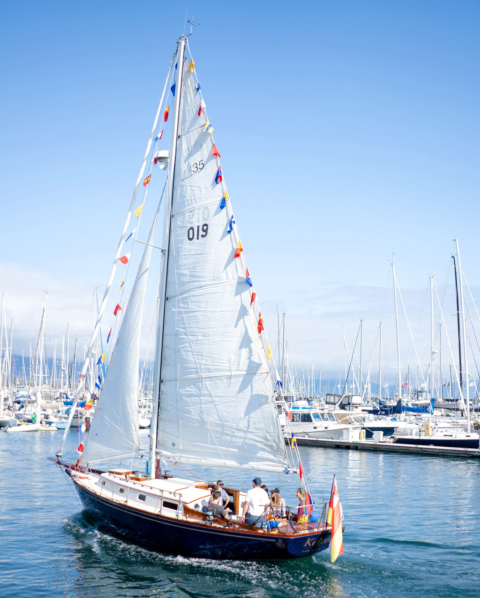 Kelpie sailing through Santa Barbara Harbor during a private harbor cruise.