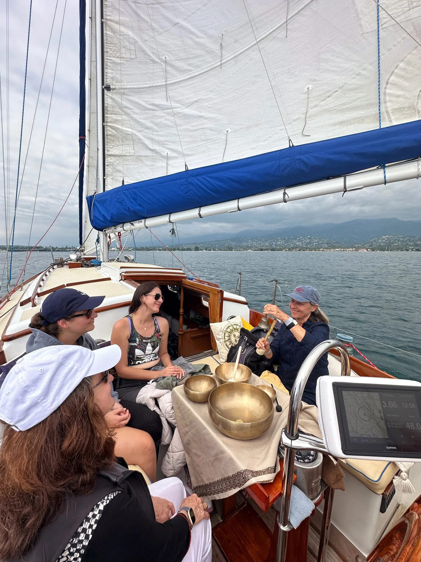 Guests relaxing during a floating sound bath aboard Yacht Kelpie in Santa Barbara