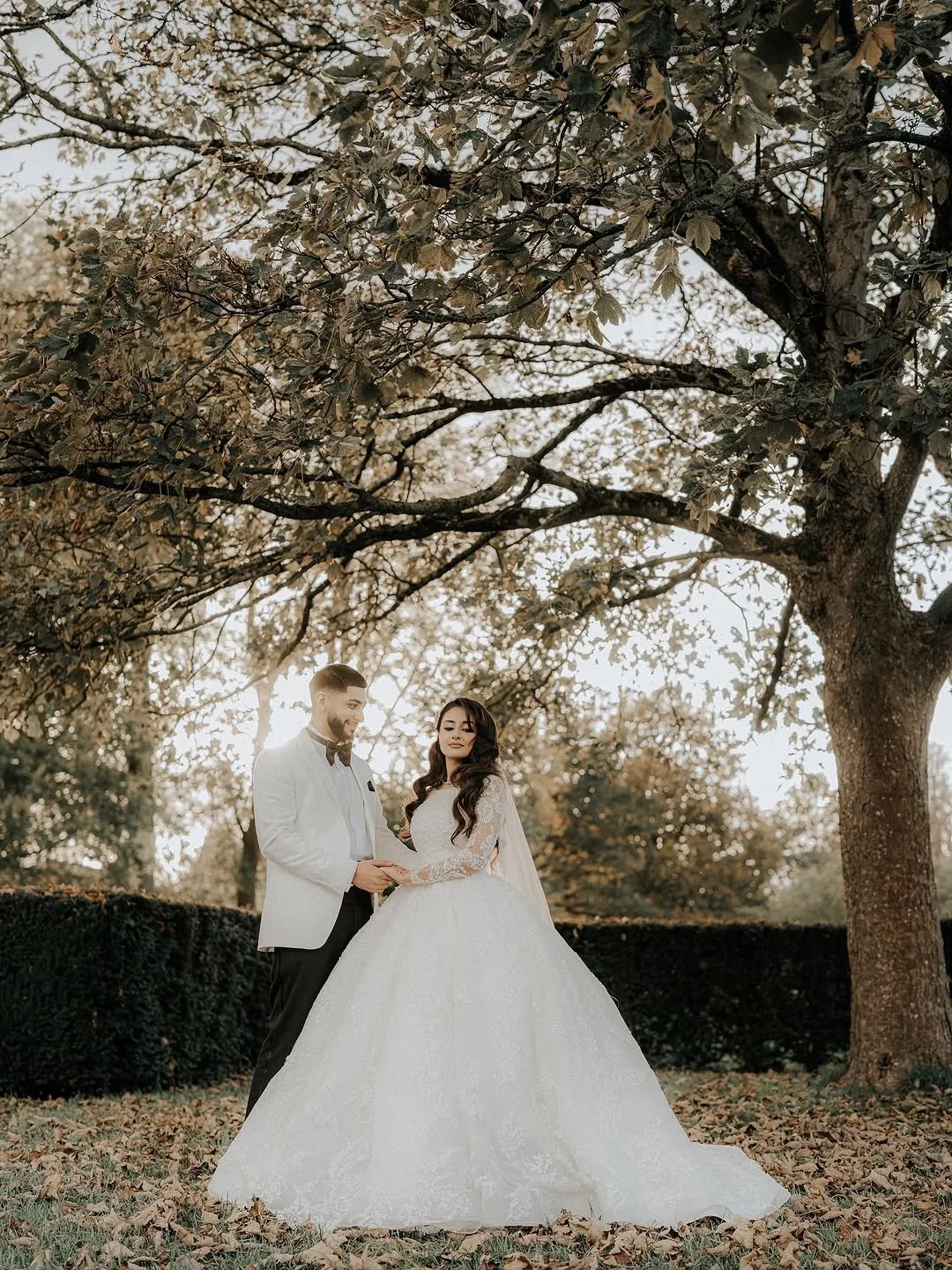Sewing materials on beige fabric including scissors, measuring tape, thread spool, and bobbin.