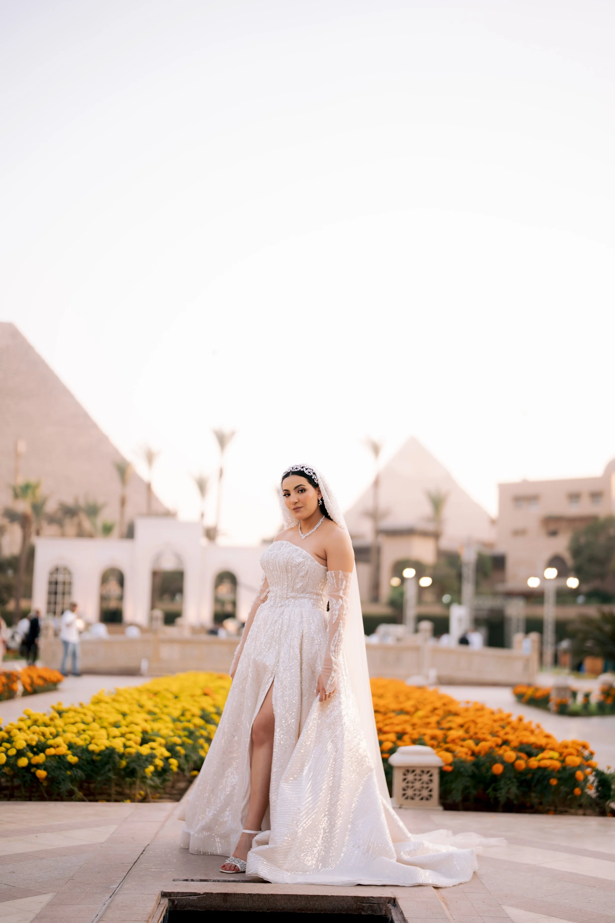 Sewing materials on beige fabric including scissors, measuring tape, thread spool, and bobbin.