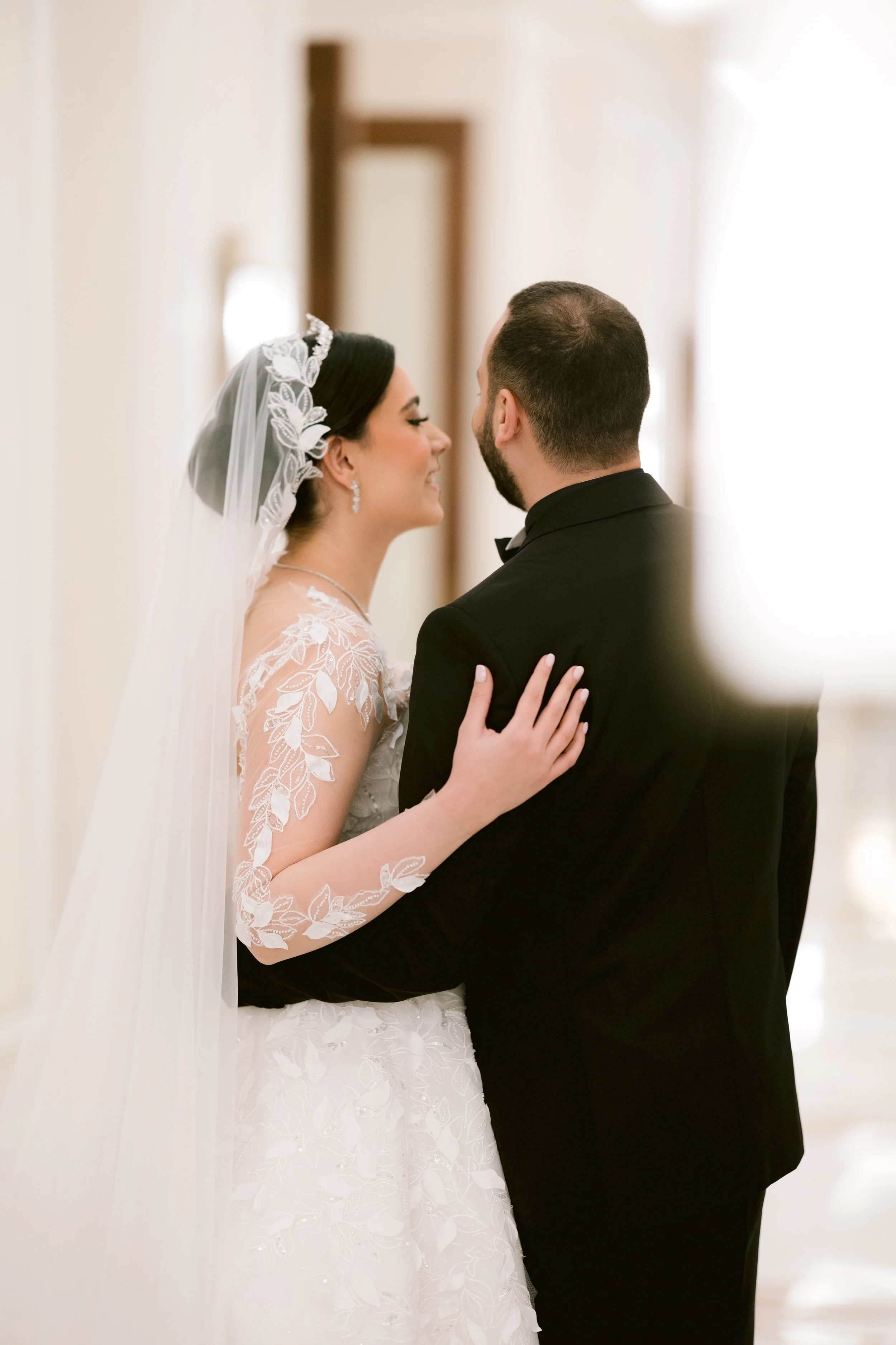 Sewing materials on beige fabric including scissors, measuring tape, thread spool, and bobbin.