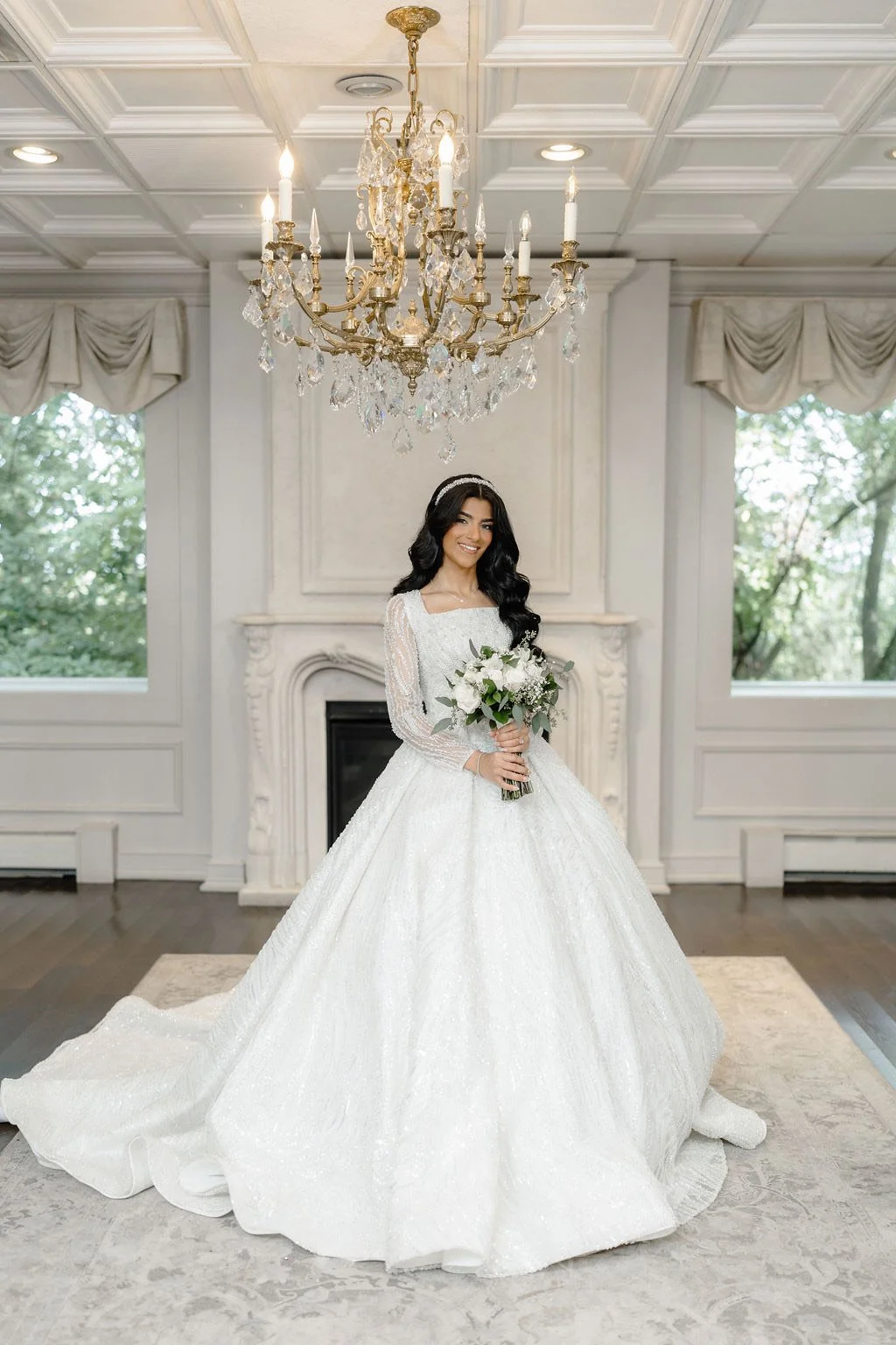 Sewing materials on beige fabric including scissors, measuring tape, thread spool, and bobbin.