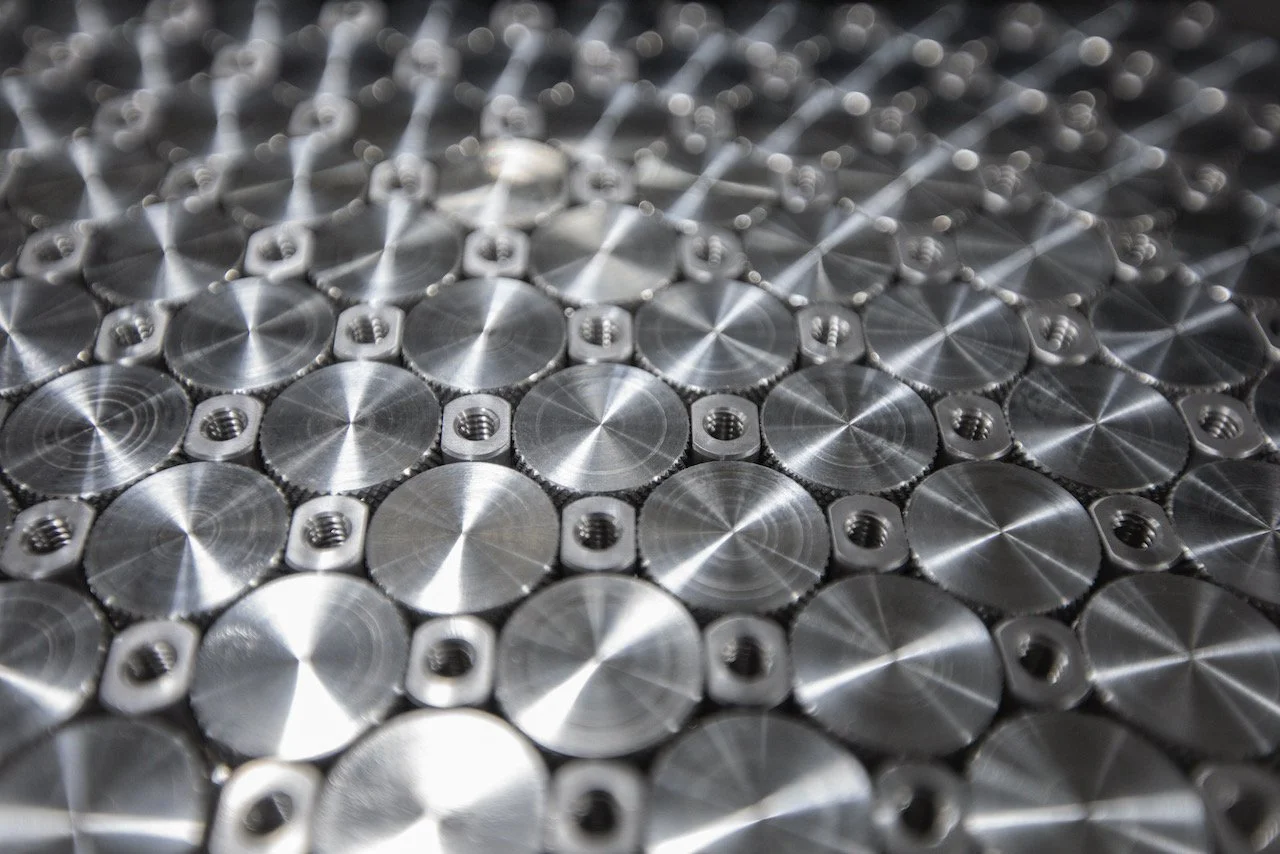 Close-up of a metallic circular pattern with threaded holes